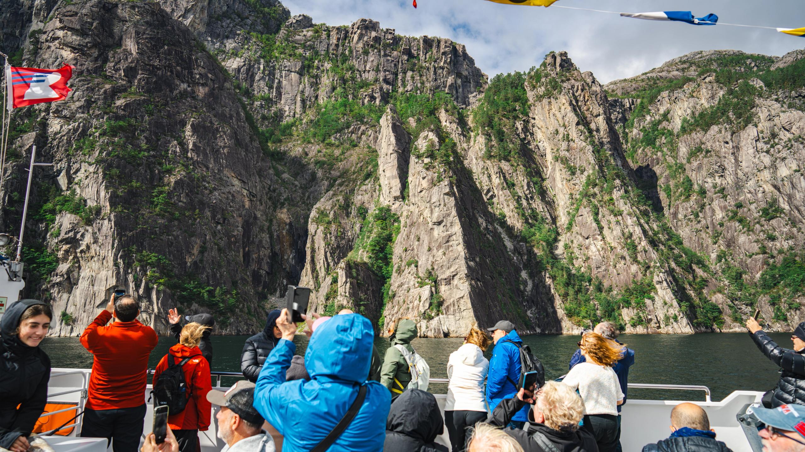 Tourists taking pictures on a cruise in the Lysefjord.