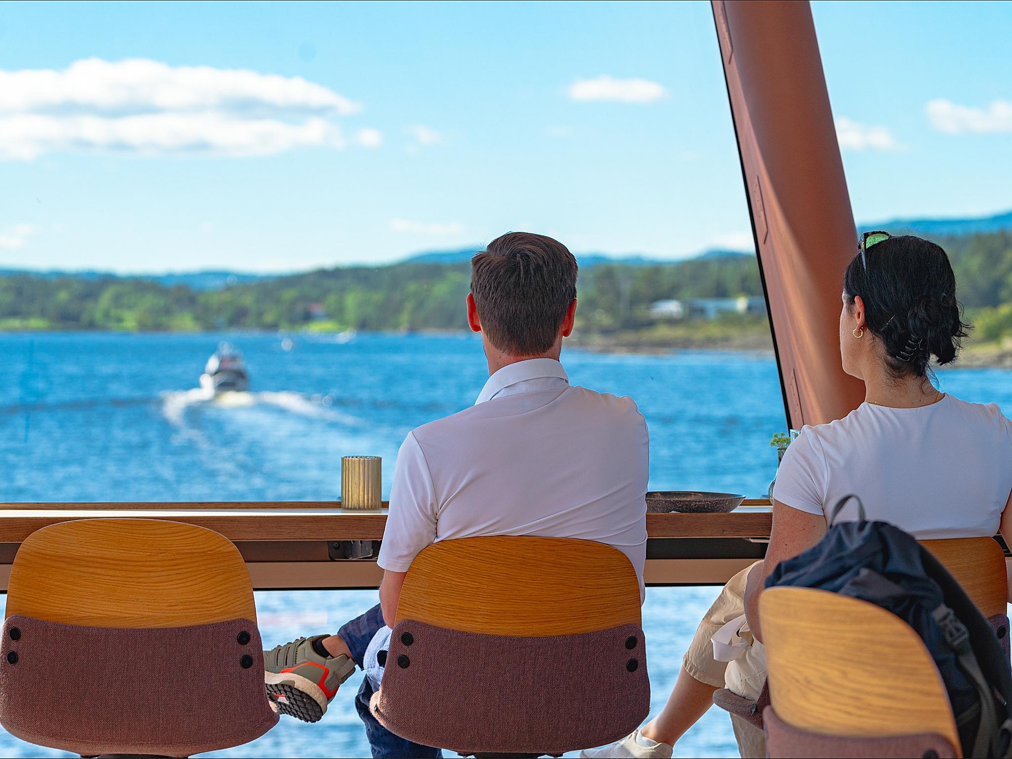 People enjoying the view from a boat on a cruise.