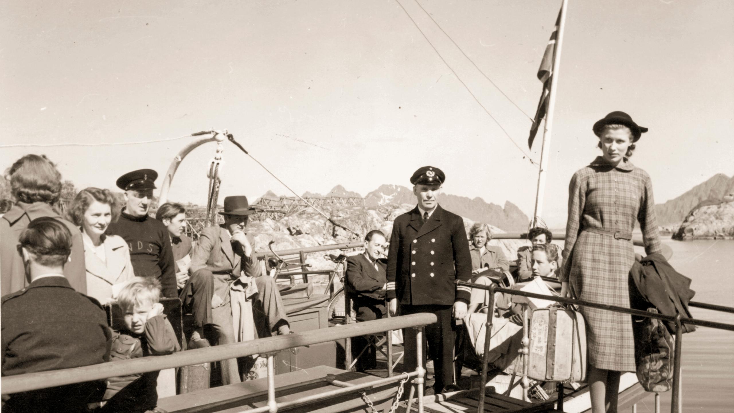 A black and white photo of a woman embarking from a Hurtigruten ship in Norway