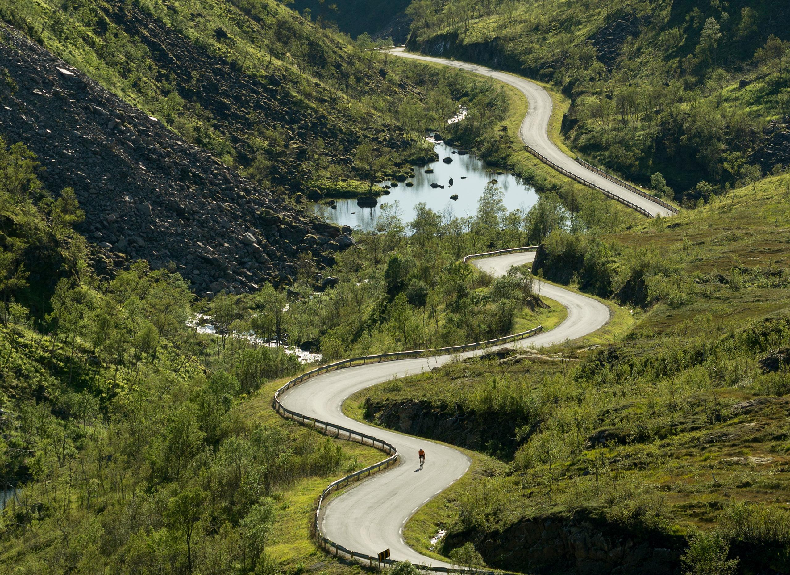 A person road cycling through Kaperskaret at Senja in Northern Norway