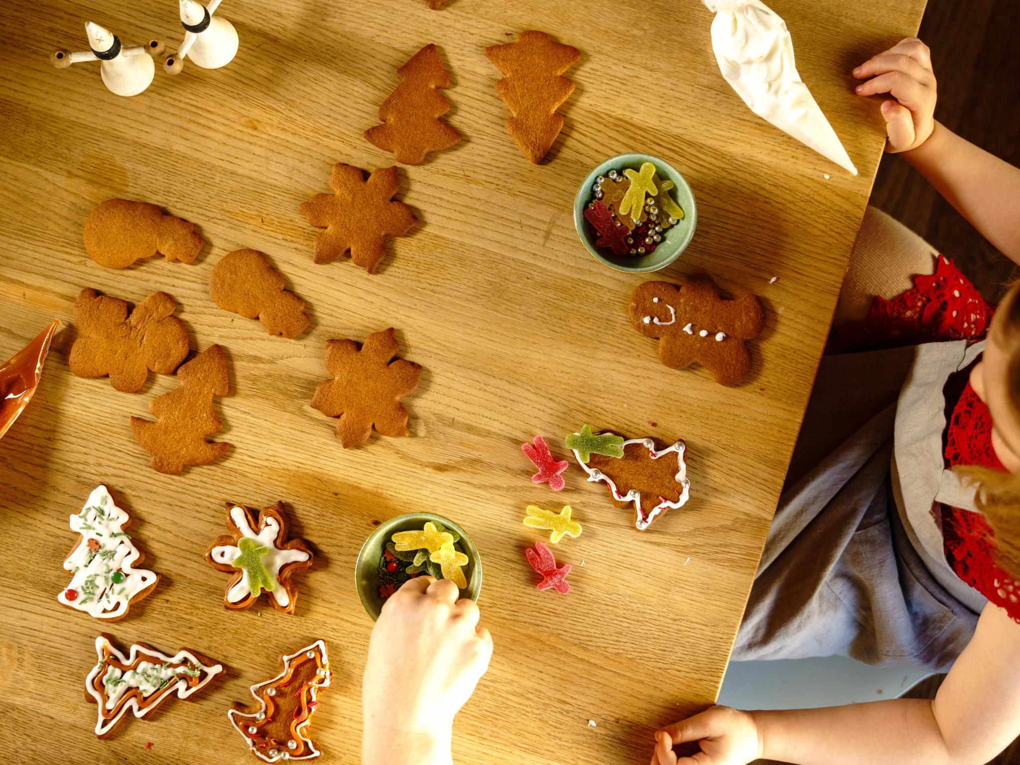 Girl decorating gingerbread cookies