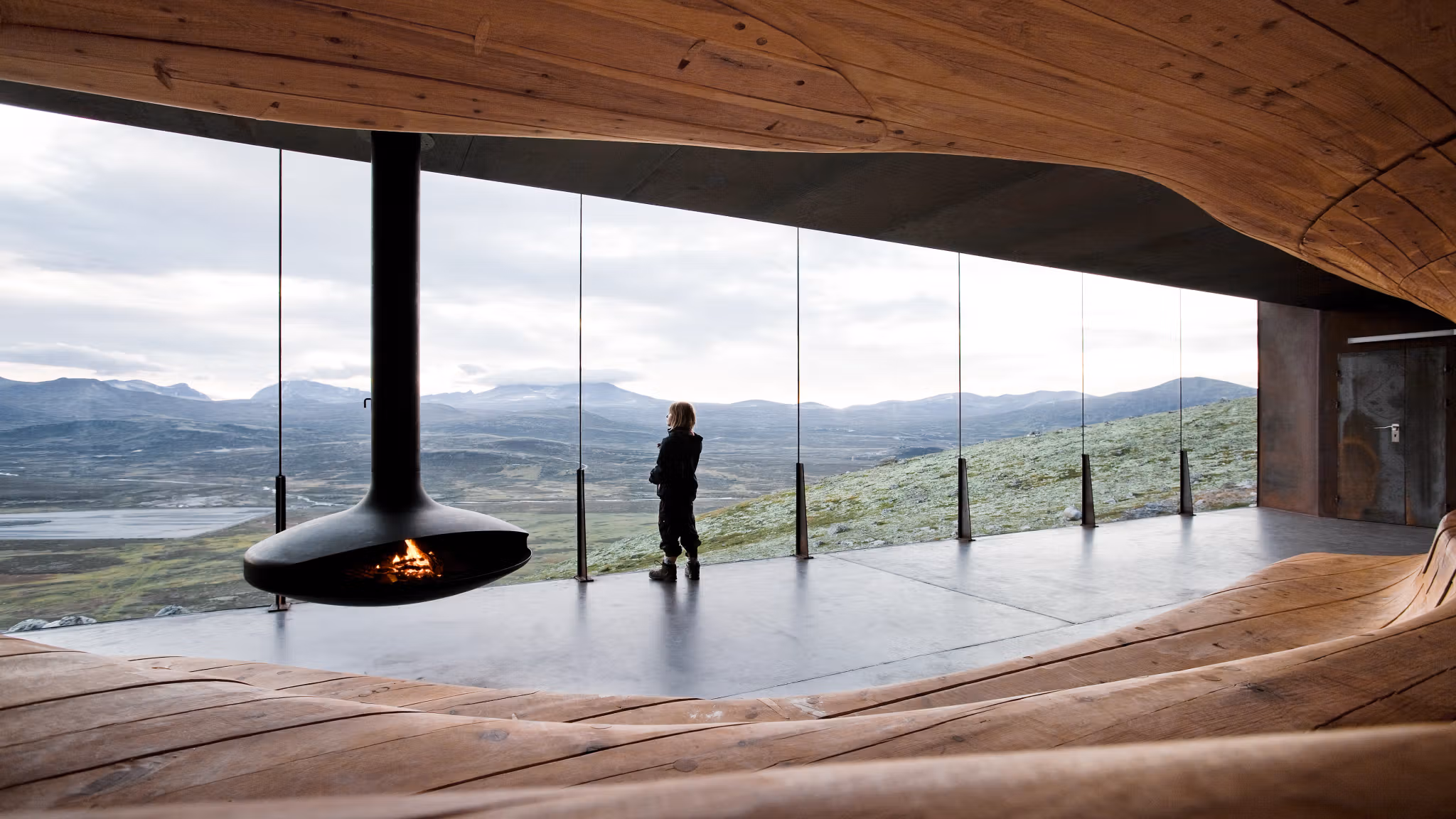 A woman enjoying the view from inside Viewpoint Snøhetta at Dovrefjell, Eastern Norway