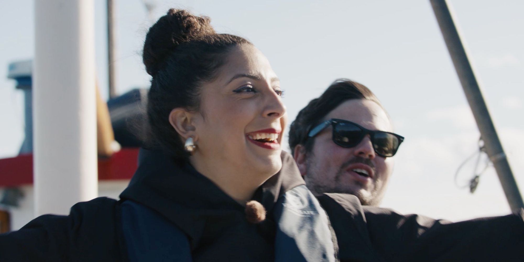 Couple standing on a boat.