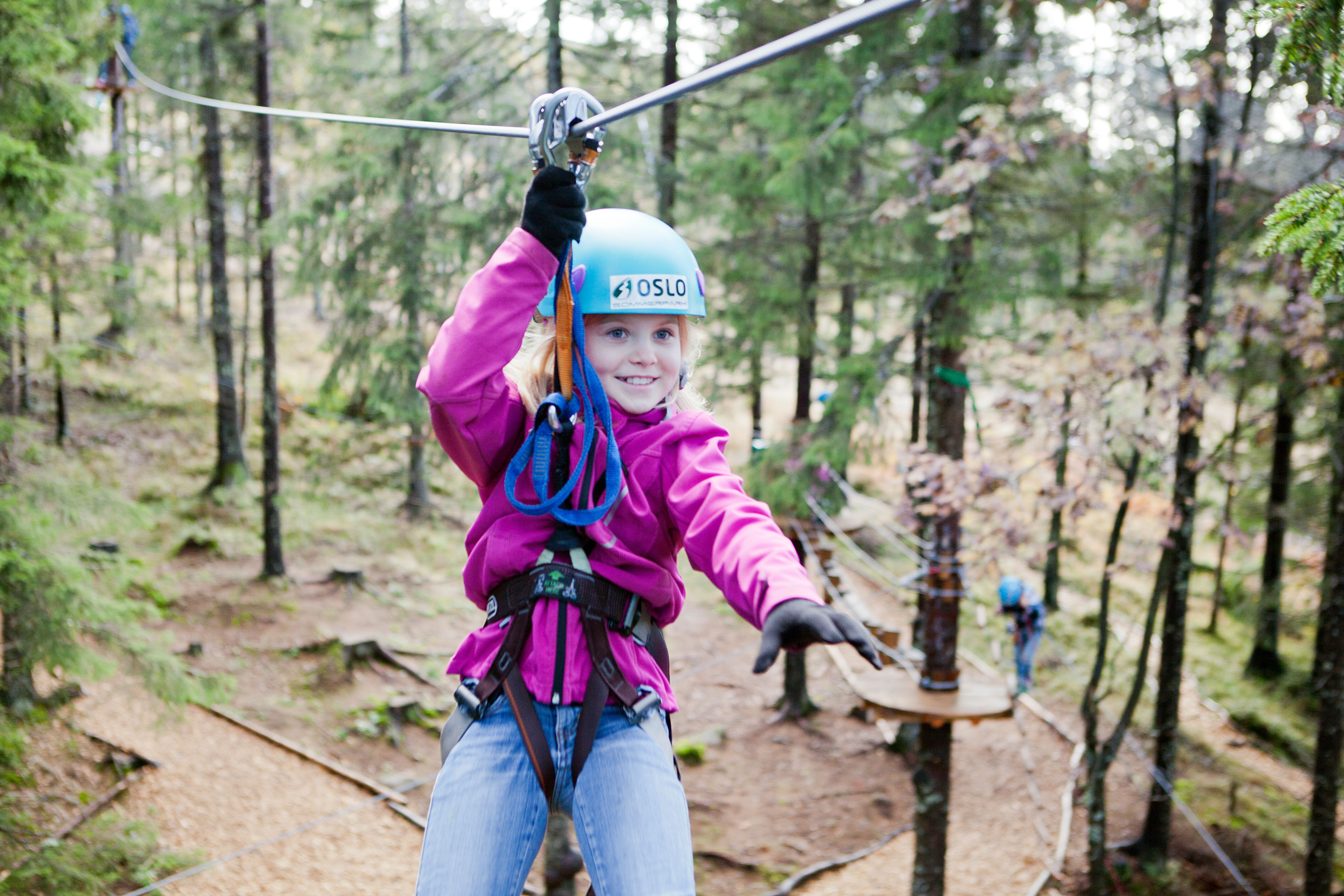 A girl in a zip line in Oslo Sommerpark, Eastern Norway