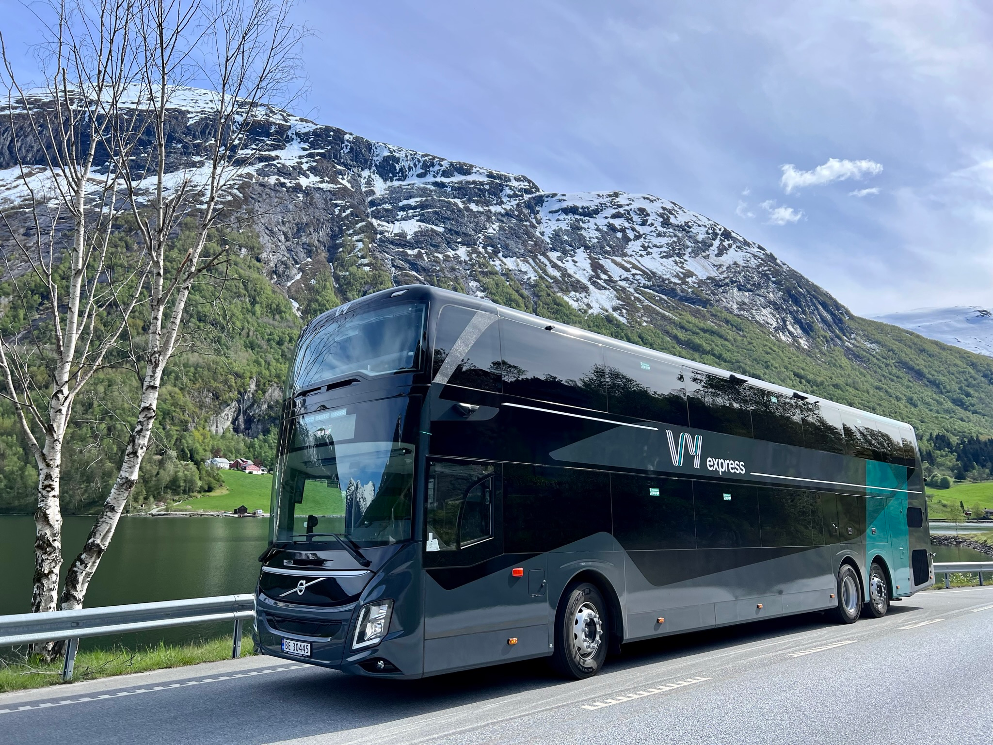 A bus running by the fjord in Norway.