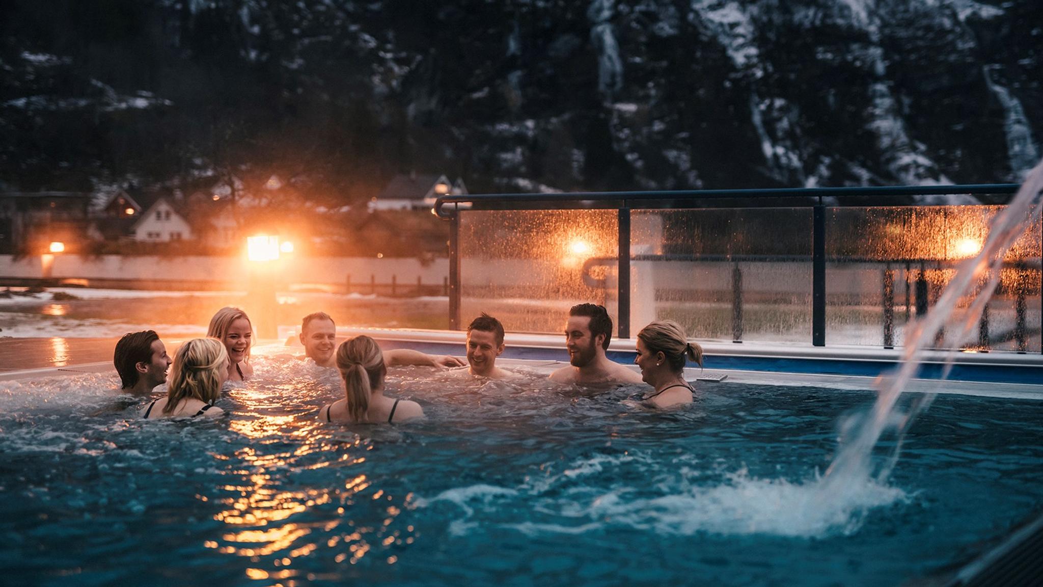 Group of people in an outdoor pool at Hotel Union Bad & Spa, Geiranger, Fjord Norway