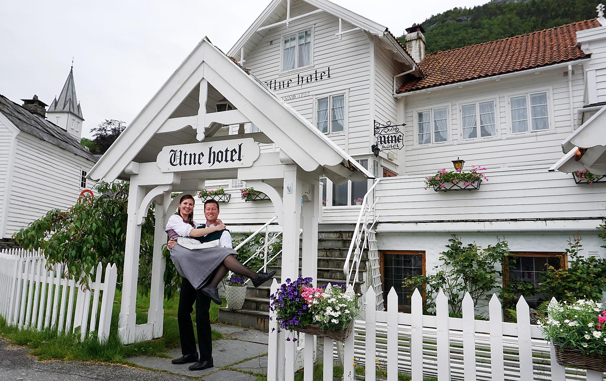 Bente R. and Kjetil Widding, owners of Utne Hotel, standing outside the hotel in the Hardangerfjord region in Fjord Norway