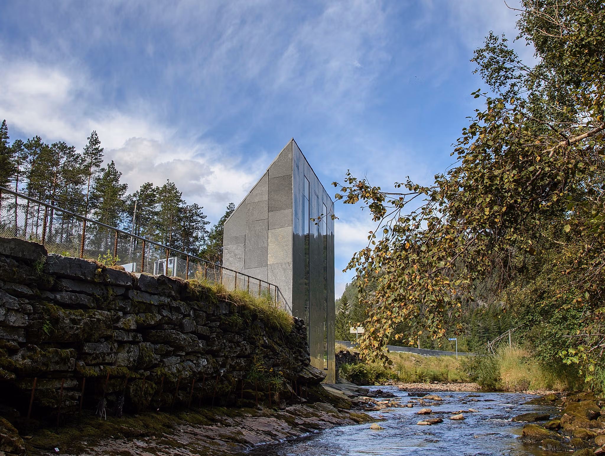 A grey architecturally designed toilet building.