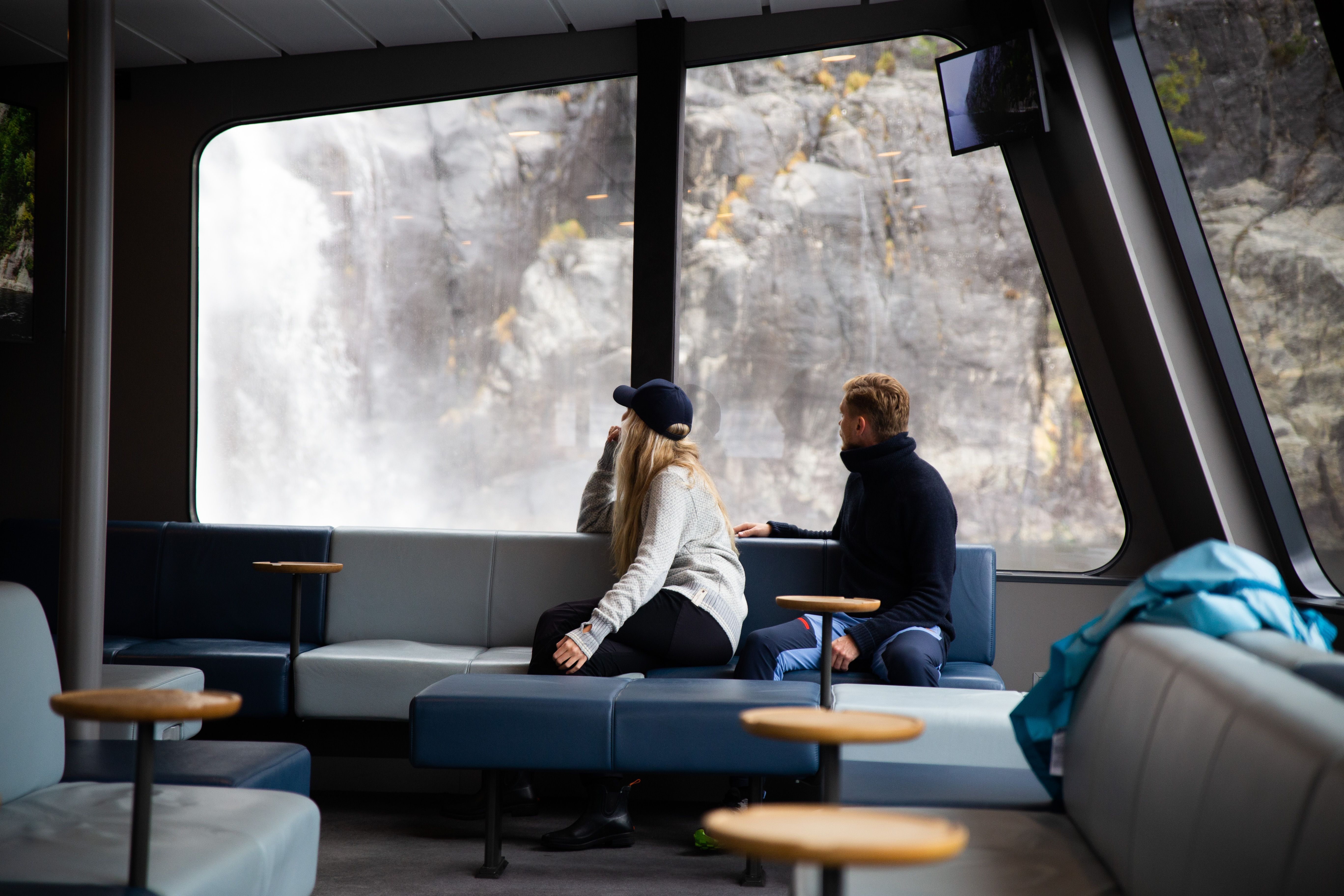 People looking out the window on a cruise.