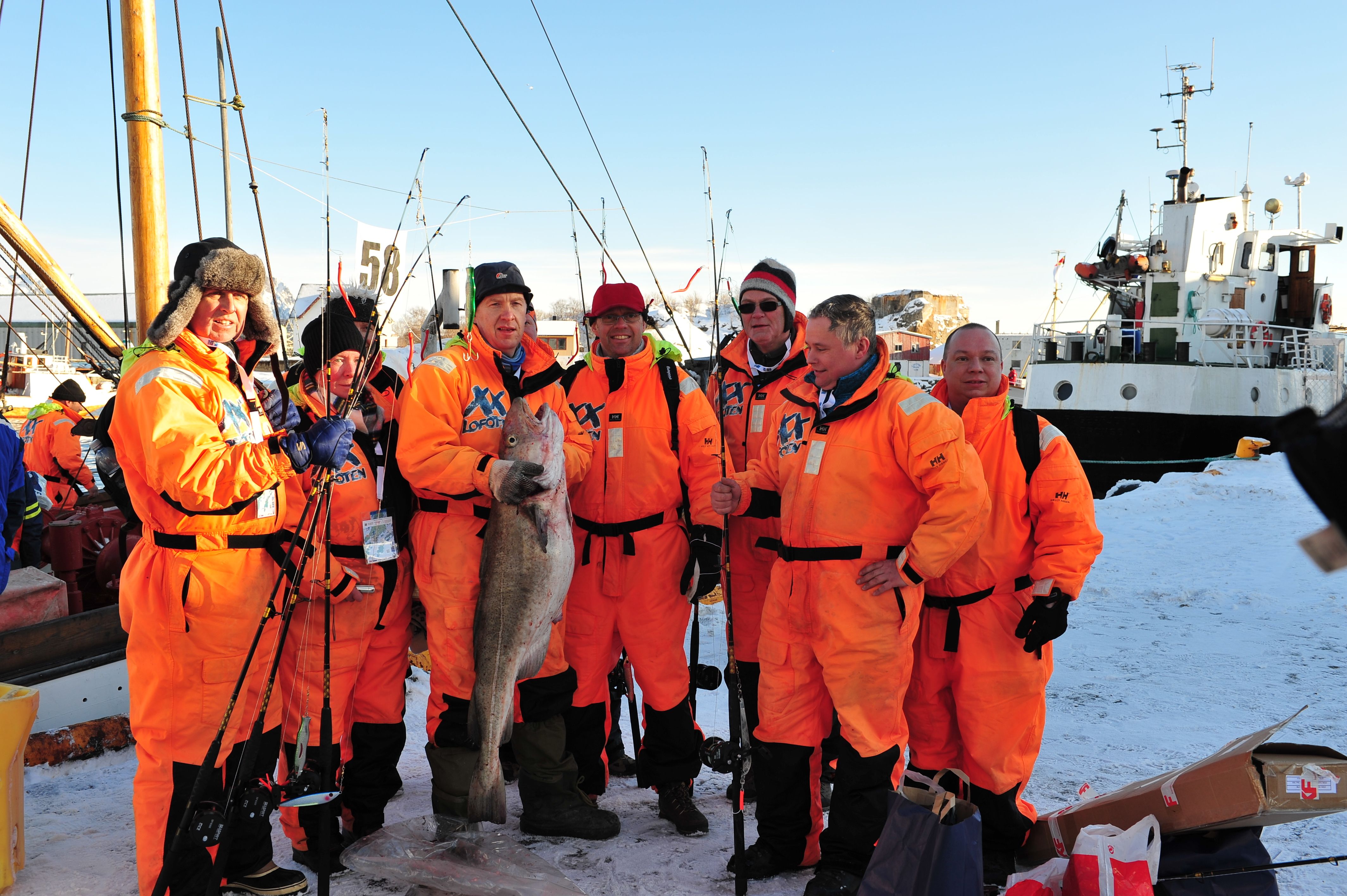 A fishing crew with an enormous cod, all participating in The world cod fishing championship in Lofoten, Northern Norway
