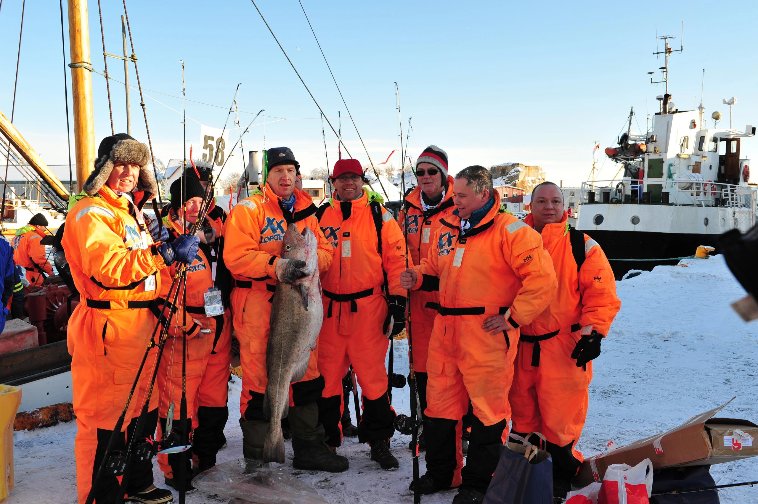 A fishing crew with an enormous cod, all participating in The world cod fishing championship in Lofoten, Northern Norway