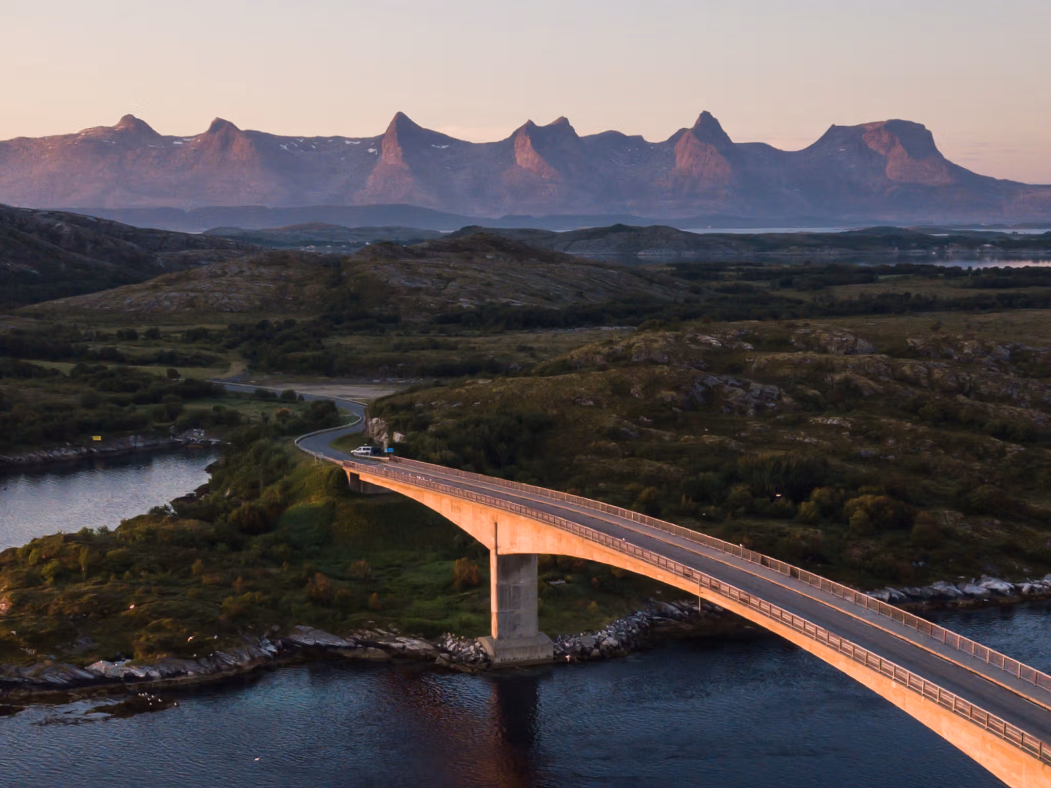 A bridge connecting Herøy to another island in Helegeland, Northern Norway. In the background, the mountain range The seven sisters.