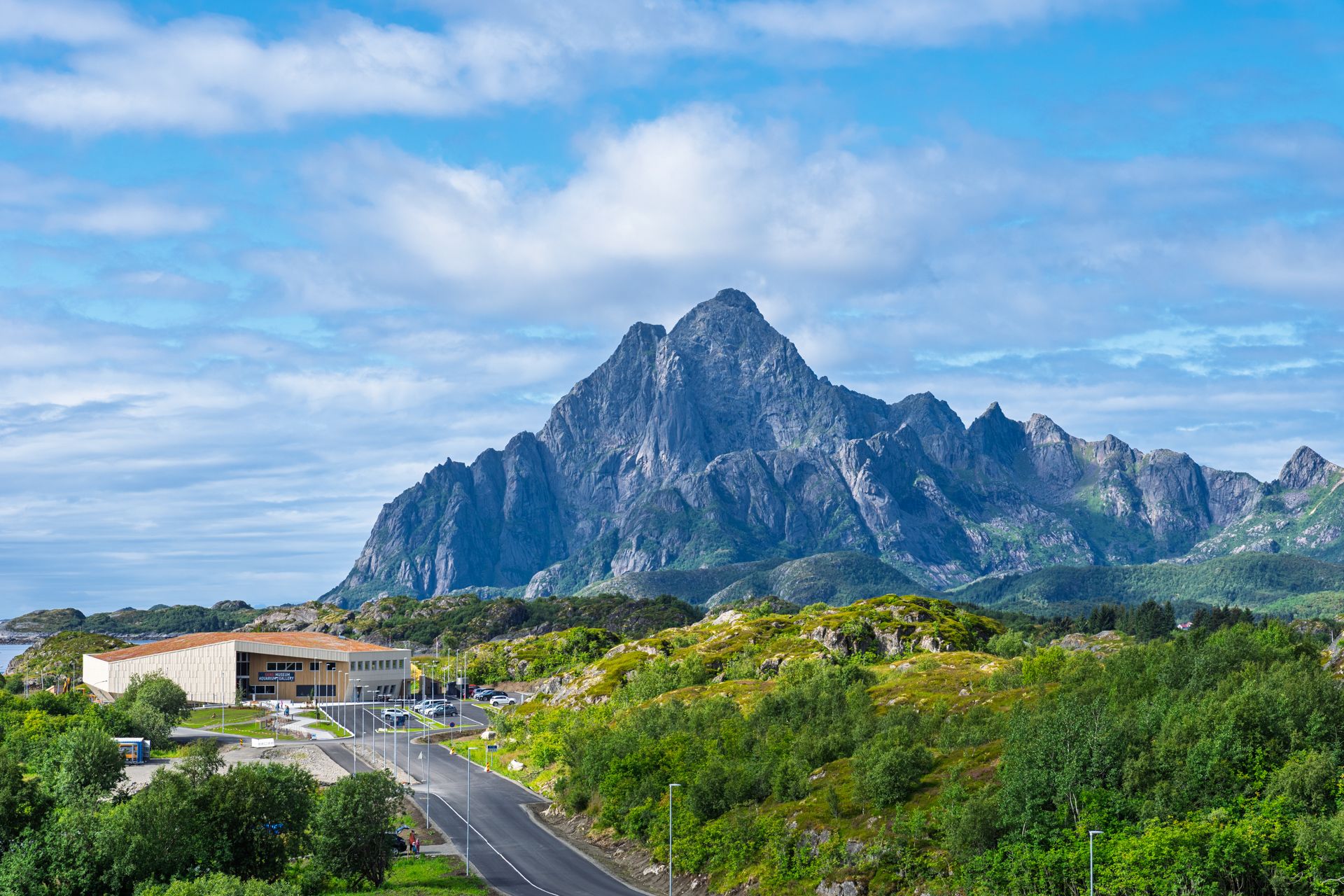 A museum next to mountains and a fjord