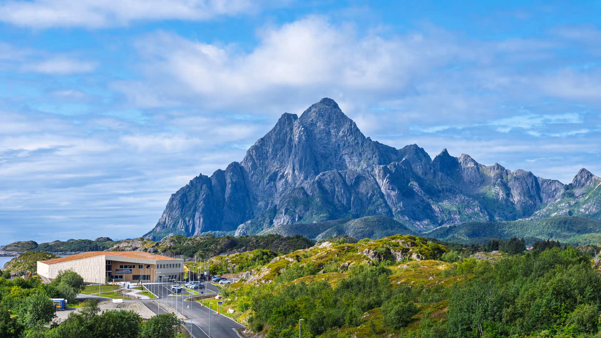 A museum next to mountains and a fjord