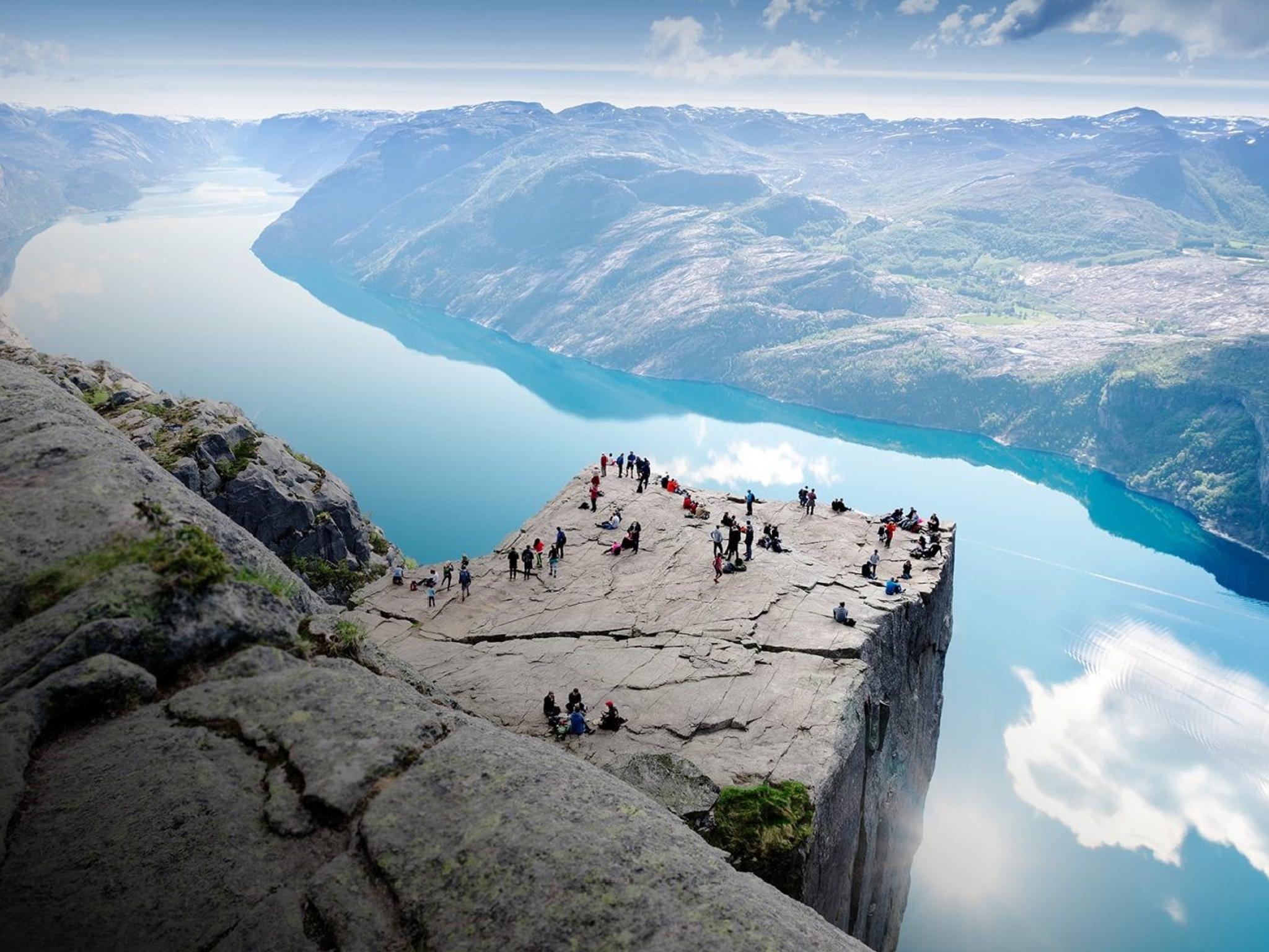 People standing on Preikestolen mountain in Lysefjorden in Fjord Norway