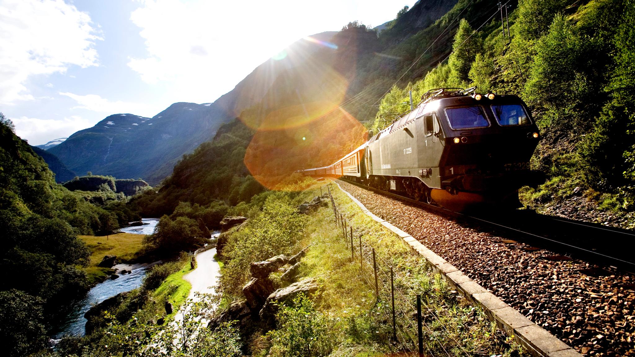 The train passes on the Flåm Railway, in Flåm