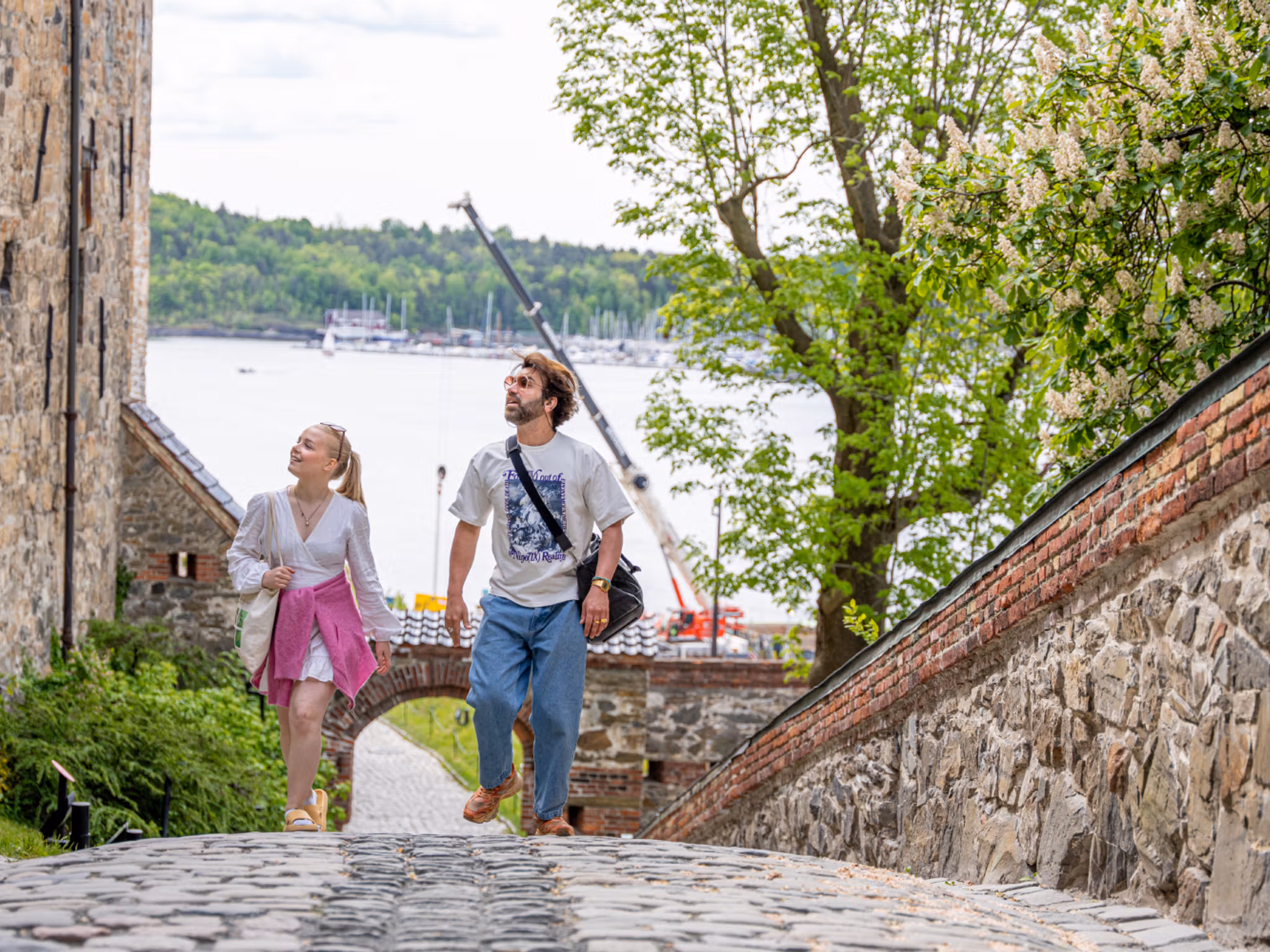 Two people sightseeing at Akershus Fortress in Oslo