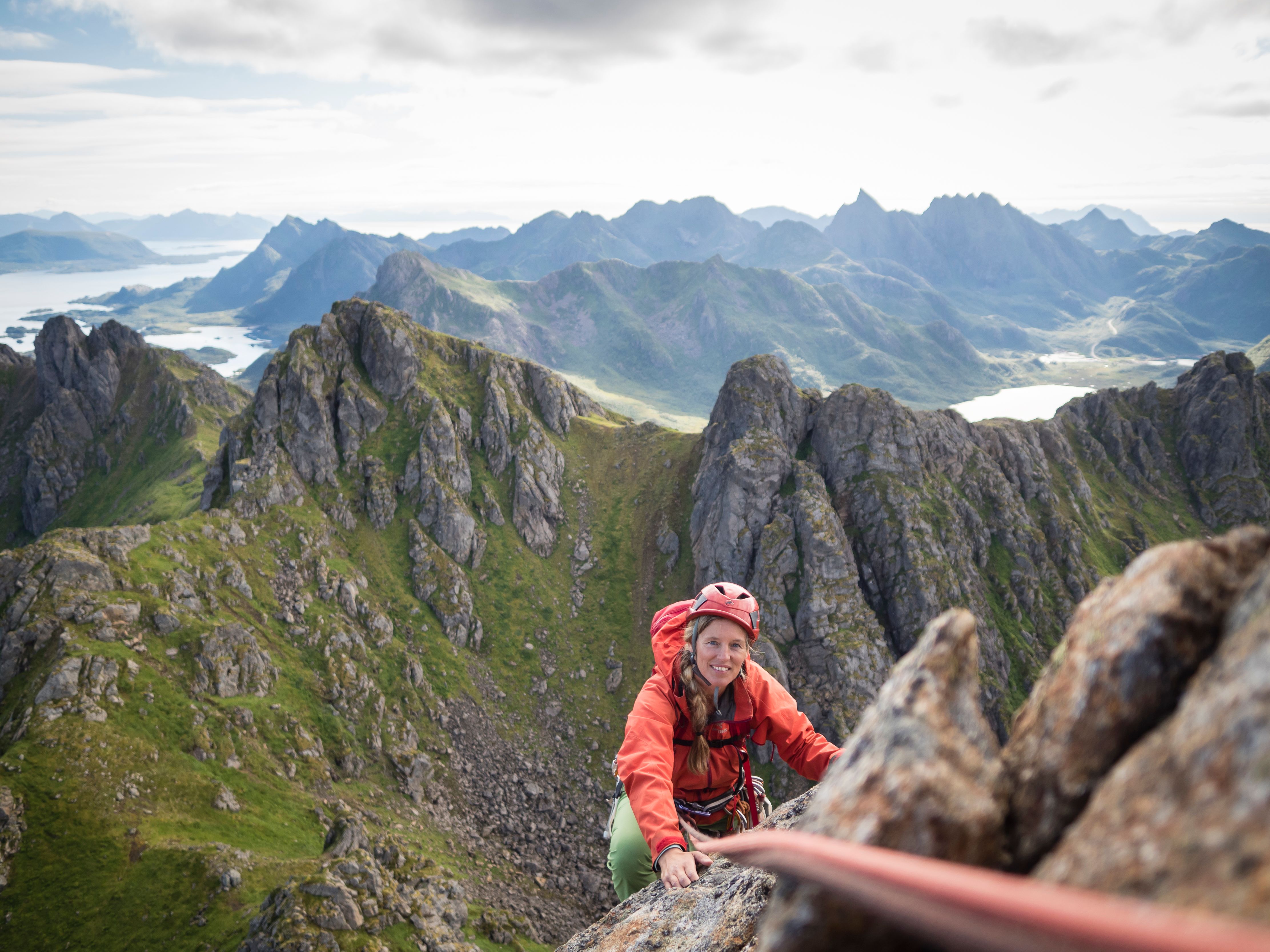 A woman climbing Reka mountain in Vesterålen in Northern Norway