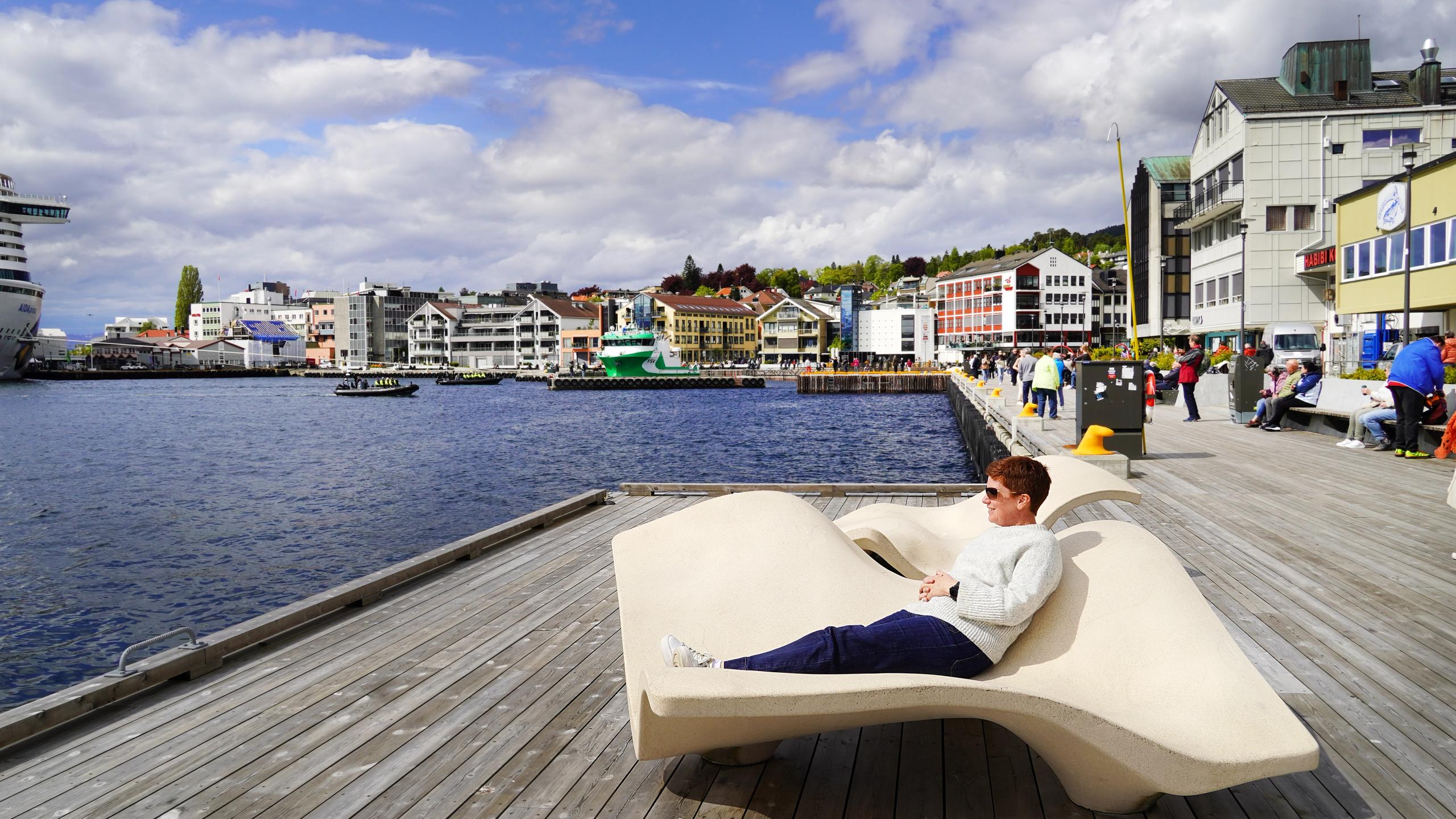 Woman relaxing on a bench at the Seafront promenade in Molde