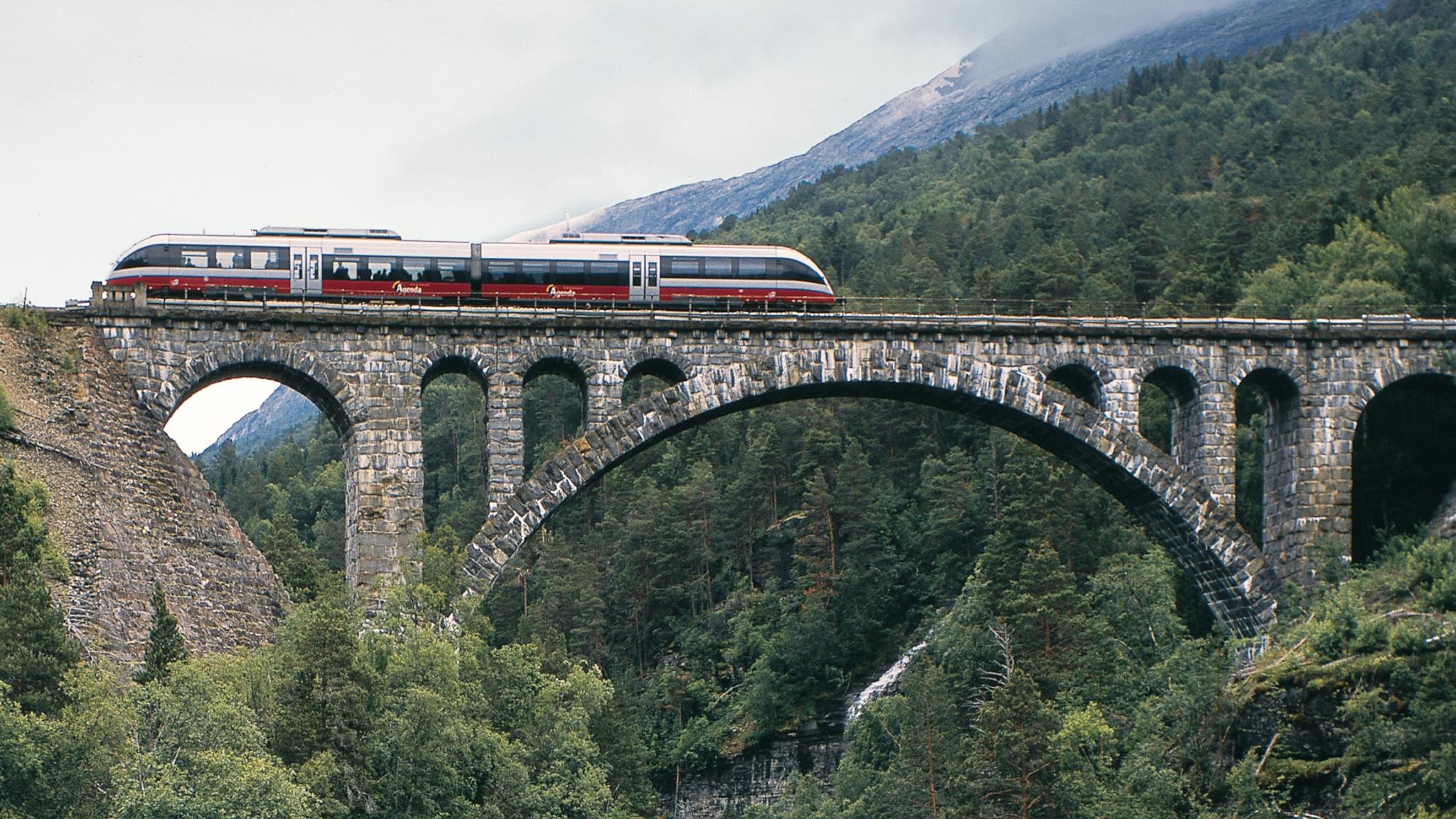 The Rauma Railway is one of the world’s best train journeys. Train crossing Kylling bridge in Rauma, Fjord Norway.