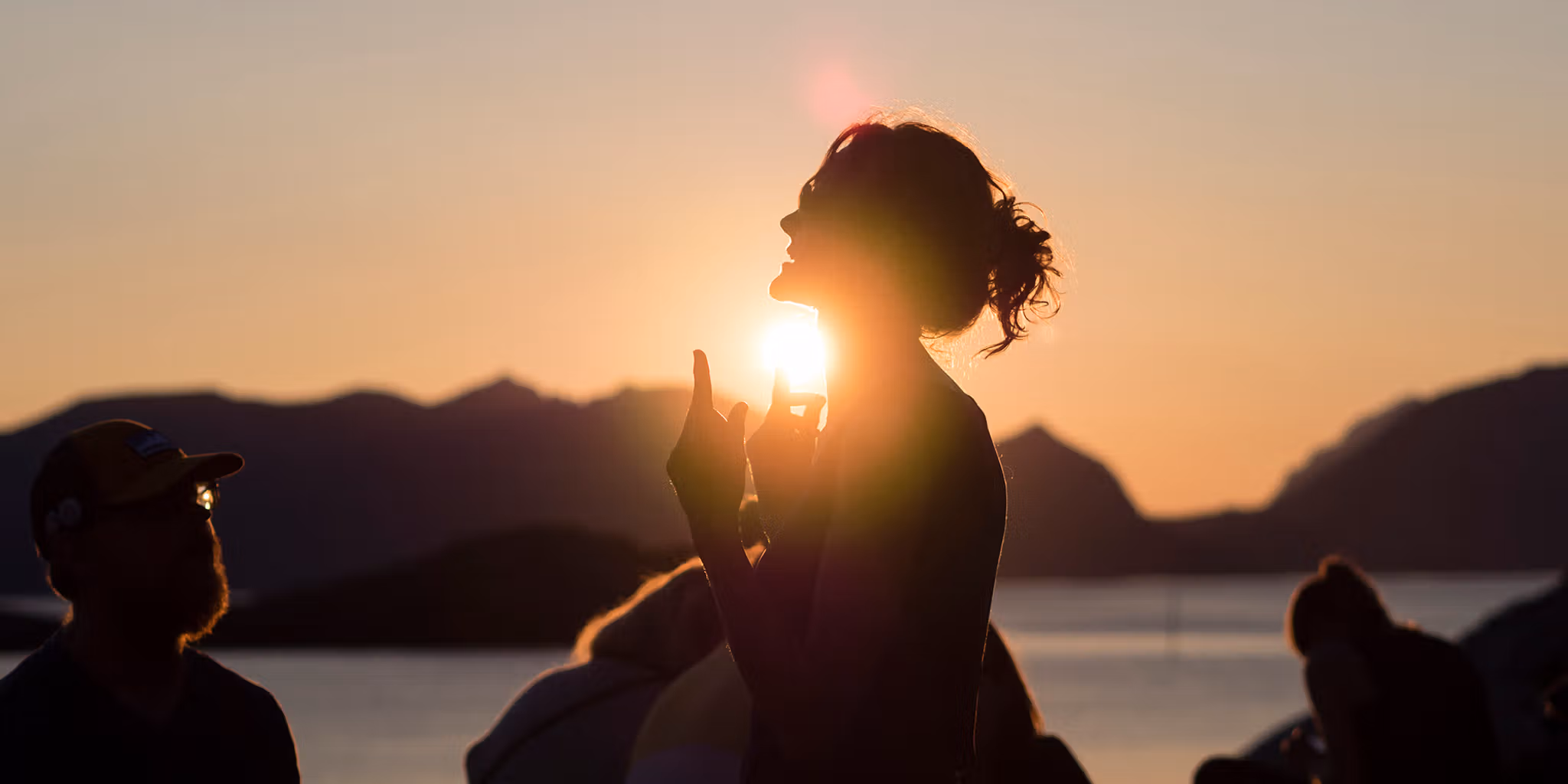 People attending the Trevarefest festival under the midnight sun in Henningsvær, Northern Norway