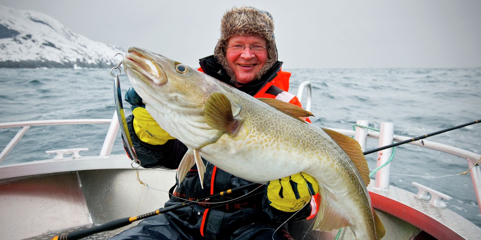 A many is very happy after a big catch.