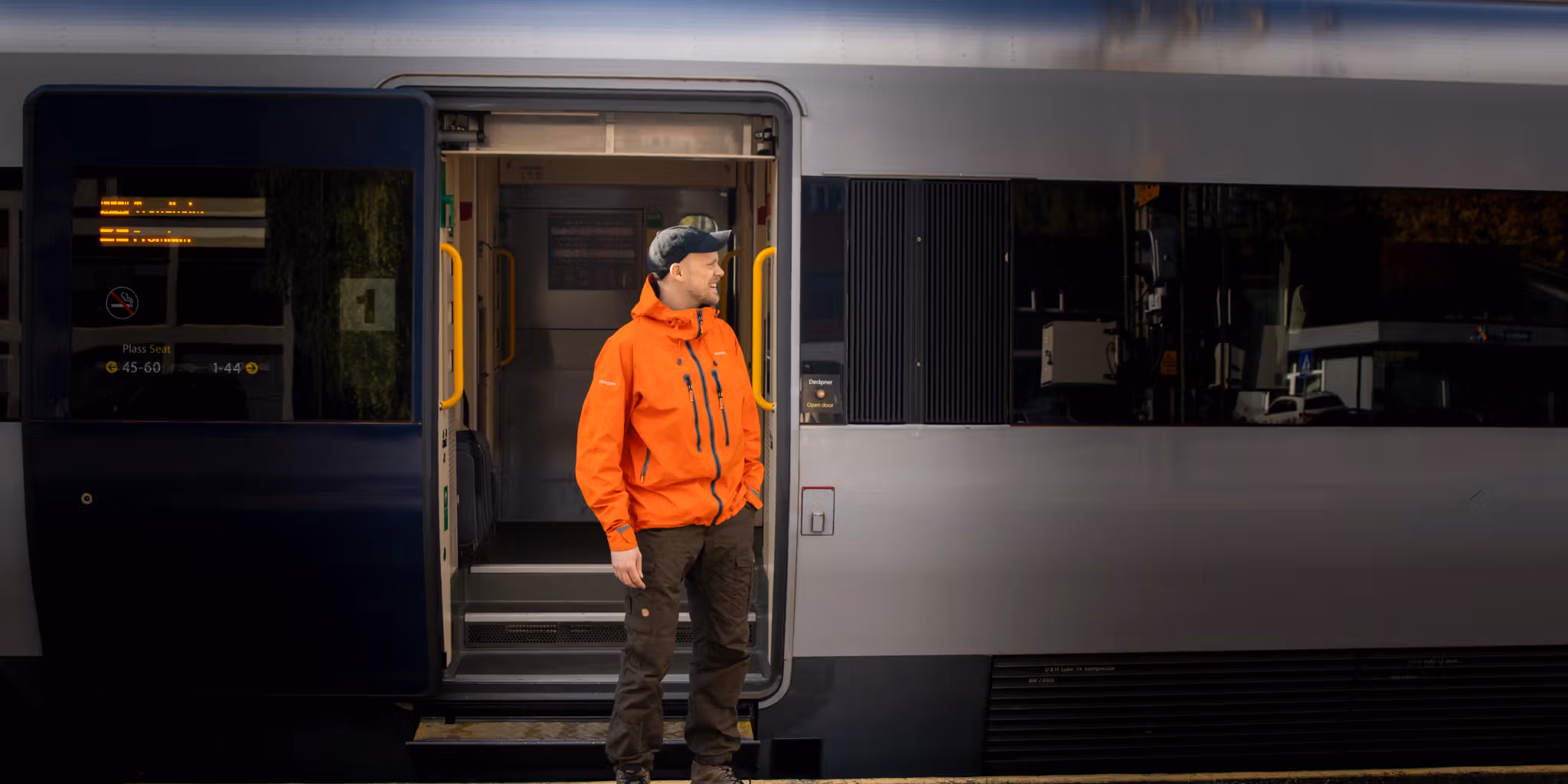 A man getting on board on the Dovre Railway train.