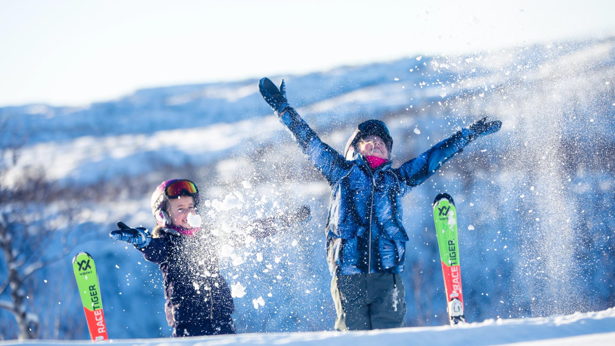 Kids having fun. throwing snow in the air