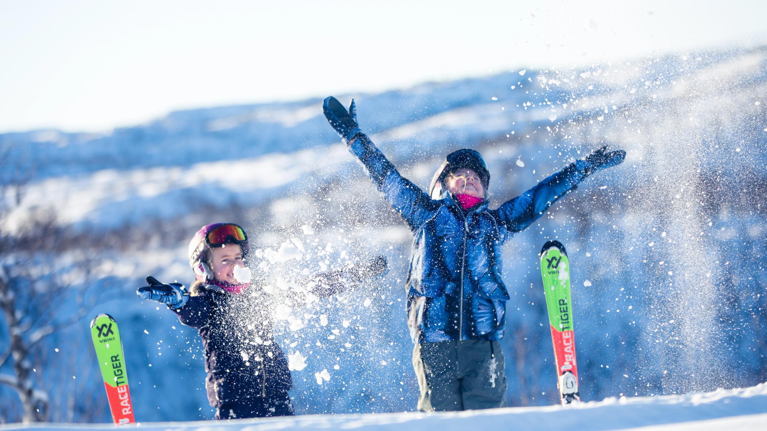 Kids having fun. throwing snow in the air