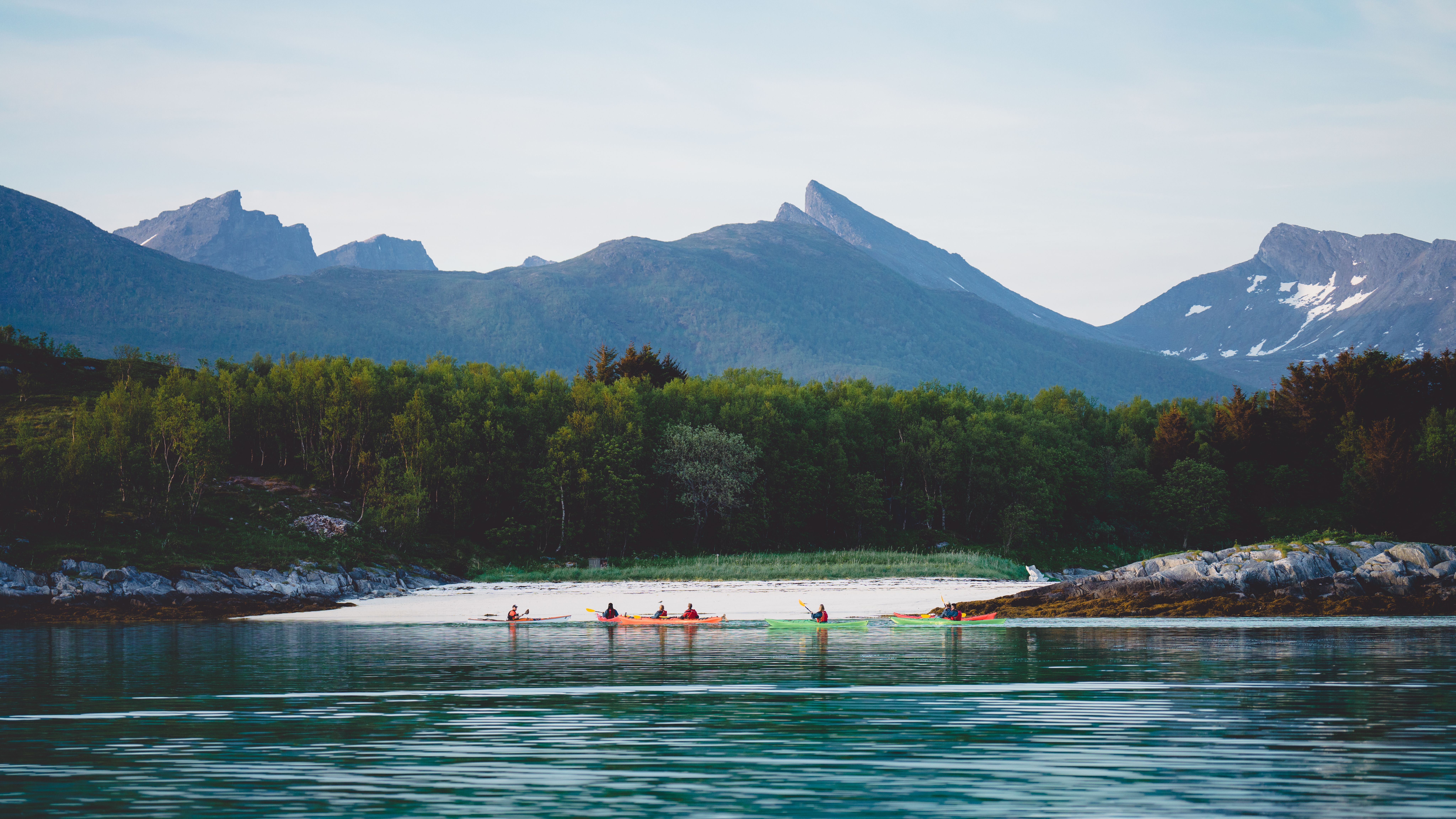 People kayaking in Senja, Troms, Northern Norway.