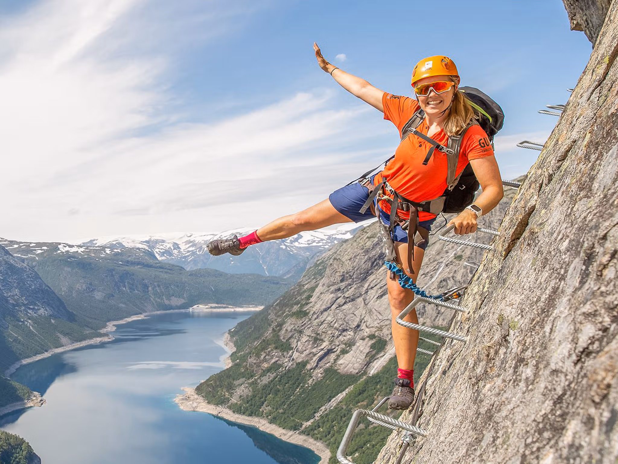 Active holiday in Norway: Woman climbing the Trolltunga via ferrata in Fjord Norway
