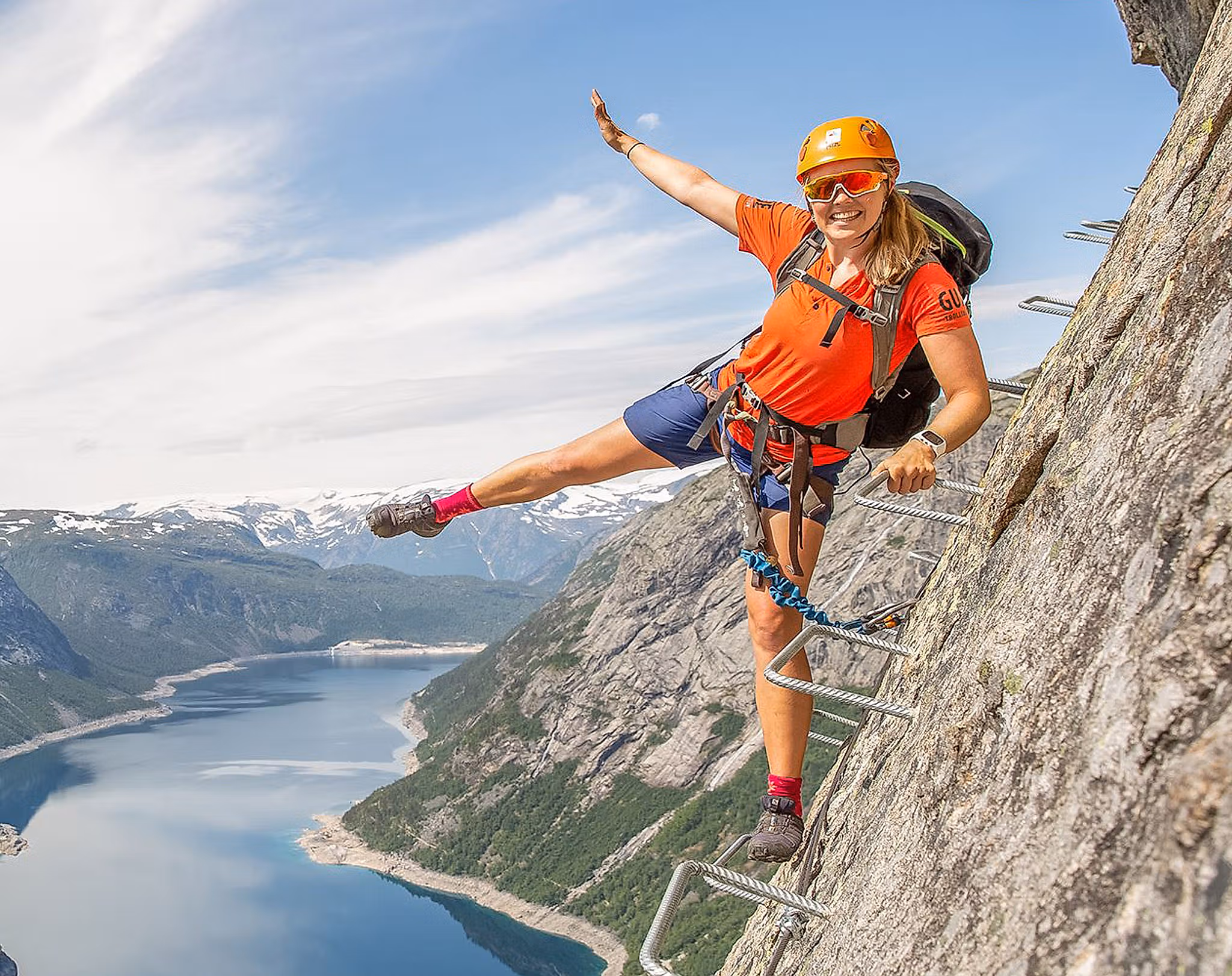 Active holiday in Norway: Woman climbing the Trolltunga via ferrata in Fjord Norway