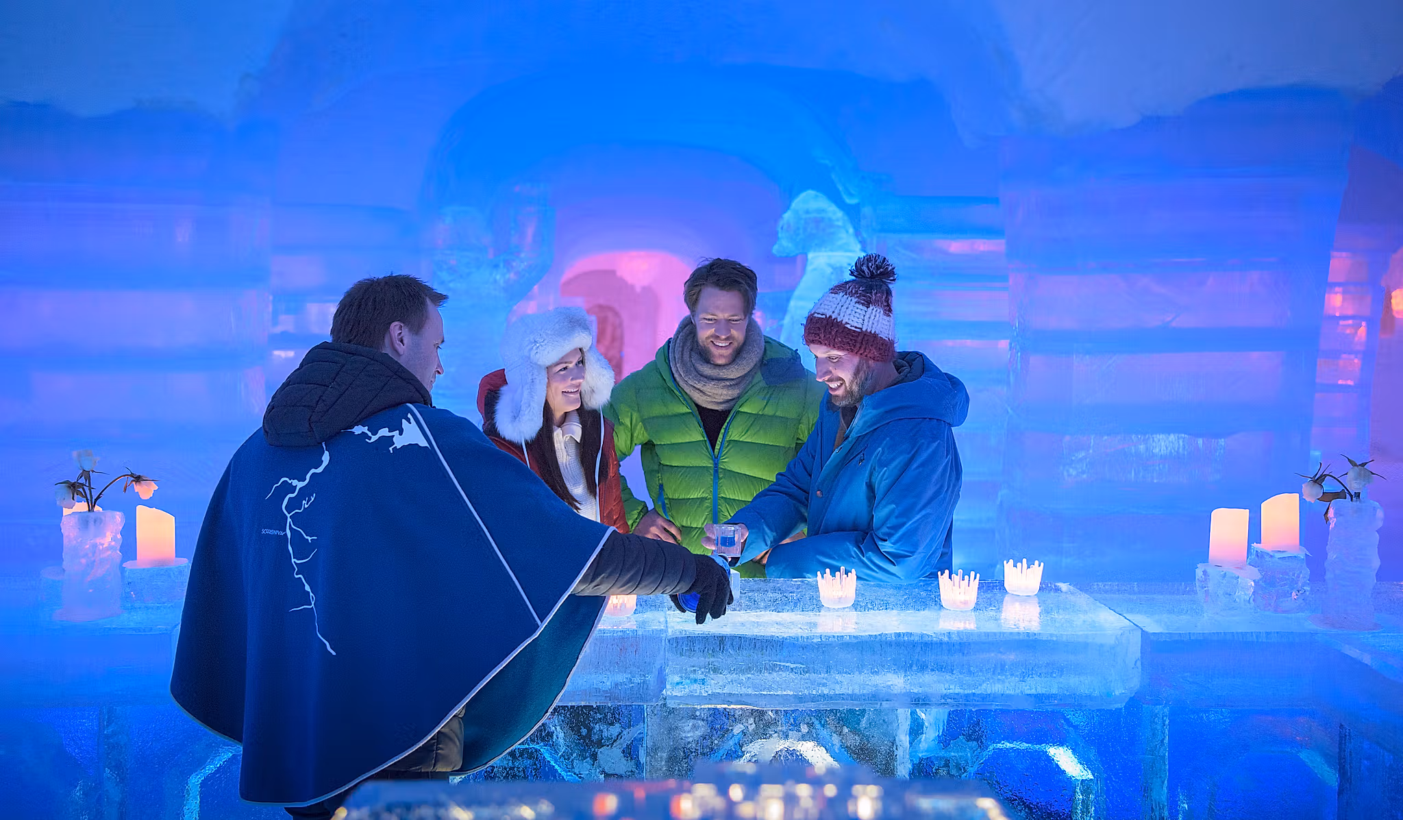 Four persons having a drink at the bar of the Sorrisniva Igloo Hotel in Alta, Northern Norway