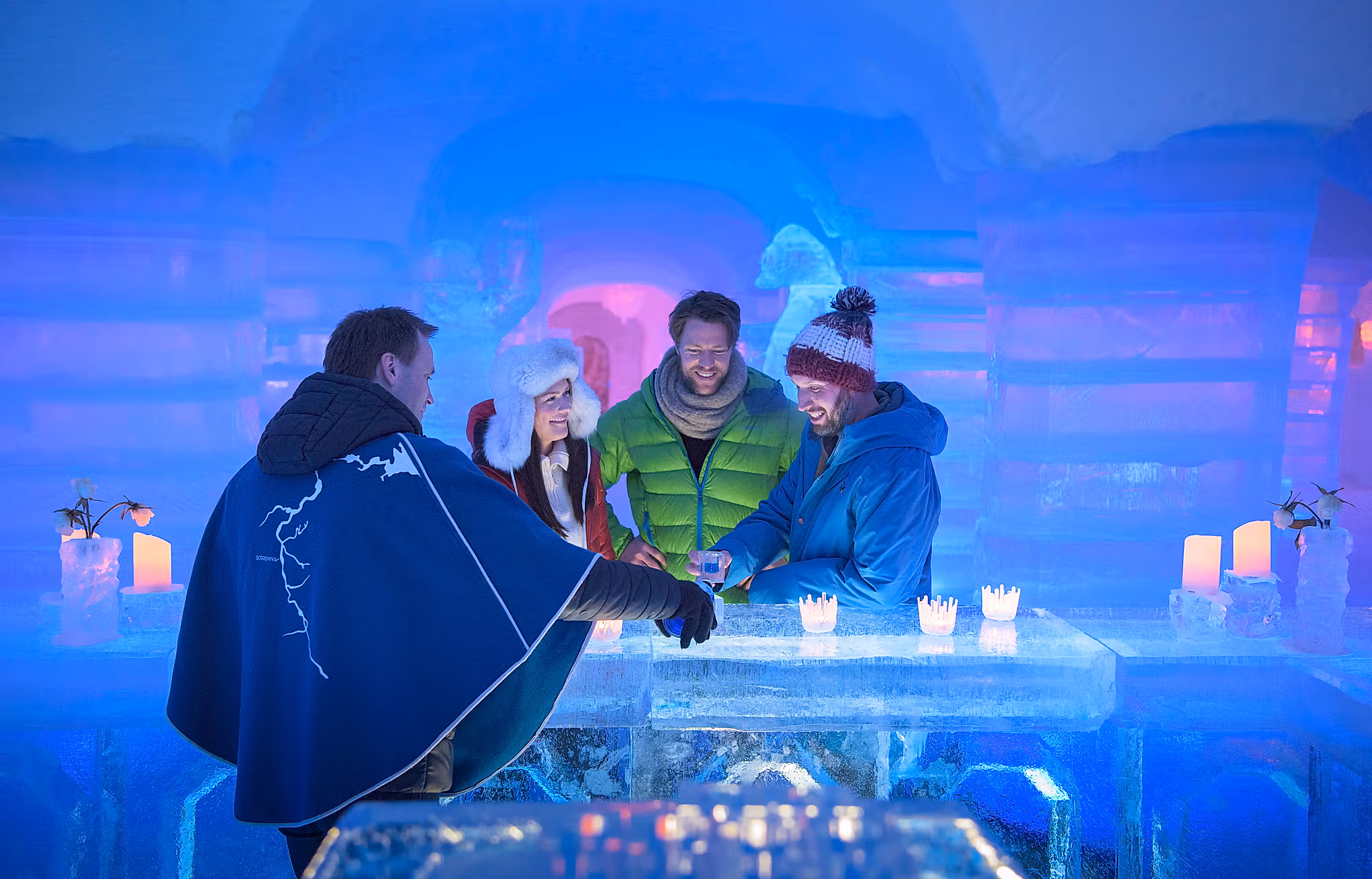 Four persons having a drink at the bar of the Sorrisniva Igloo Hotel in Alta, Northern Norway