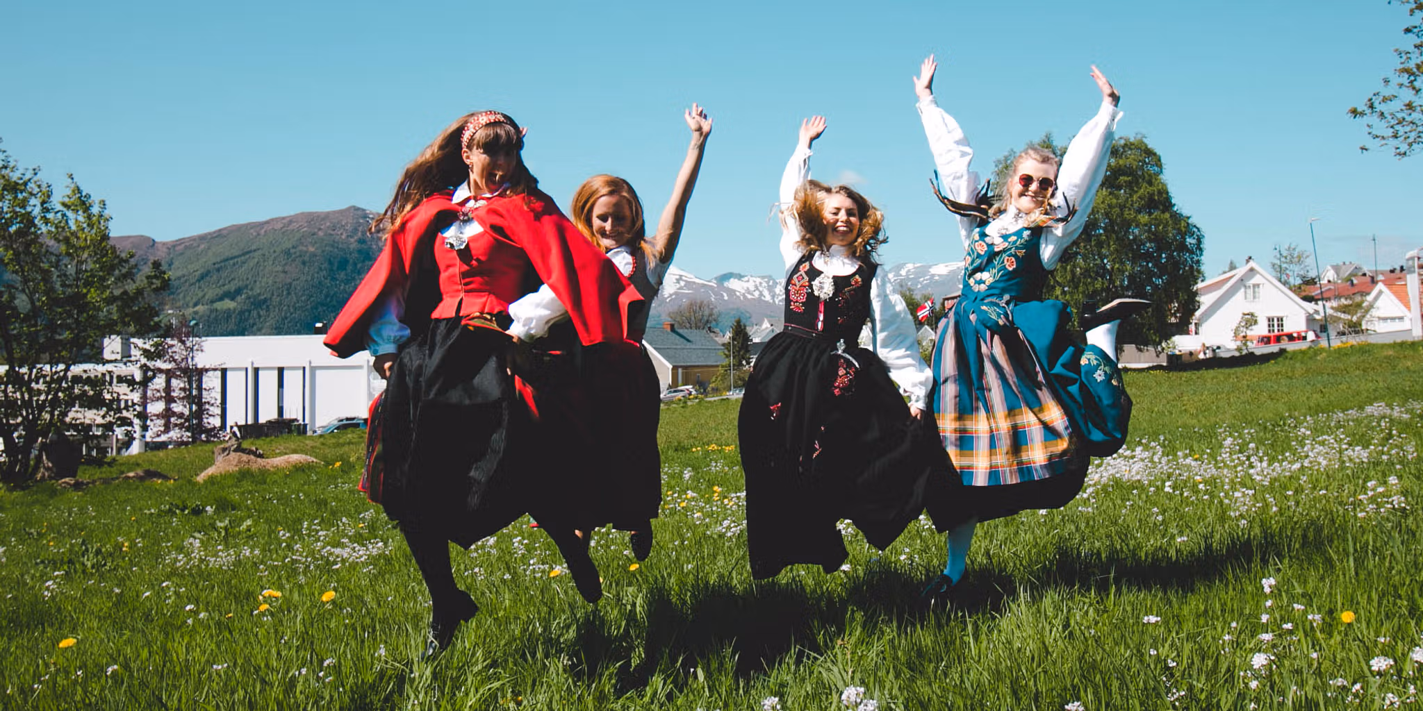 Four girls out on the field wearing bunad, the Norwegian traditional costume in Volda in Fjord Norway