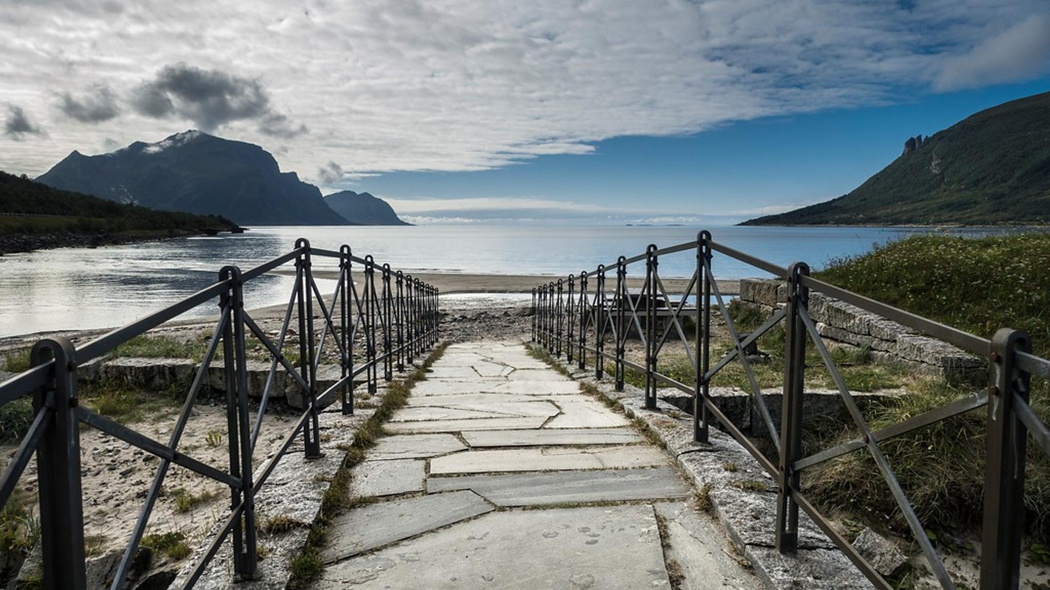 A bridge that leads to a beach.