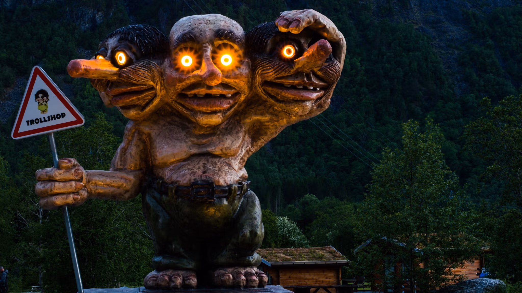 A statue of a three headed troll with lights in the eyes, Trollstigen