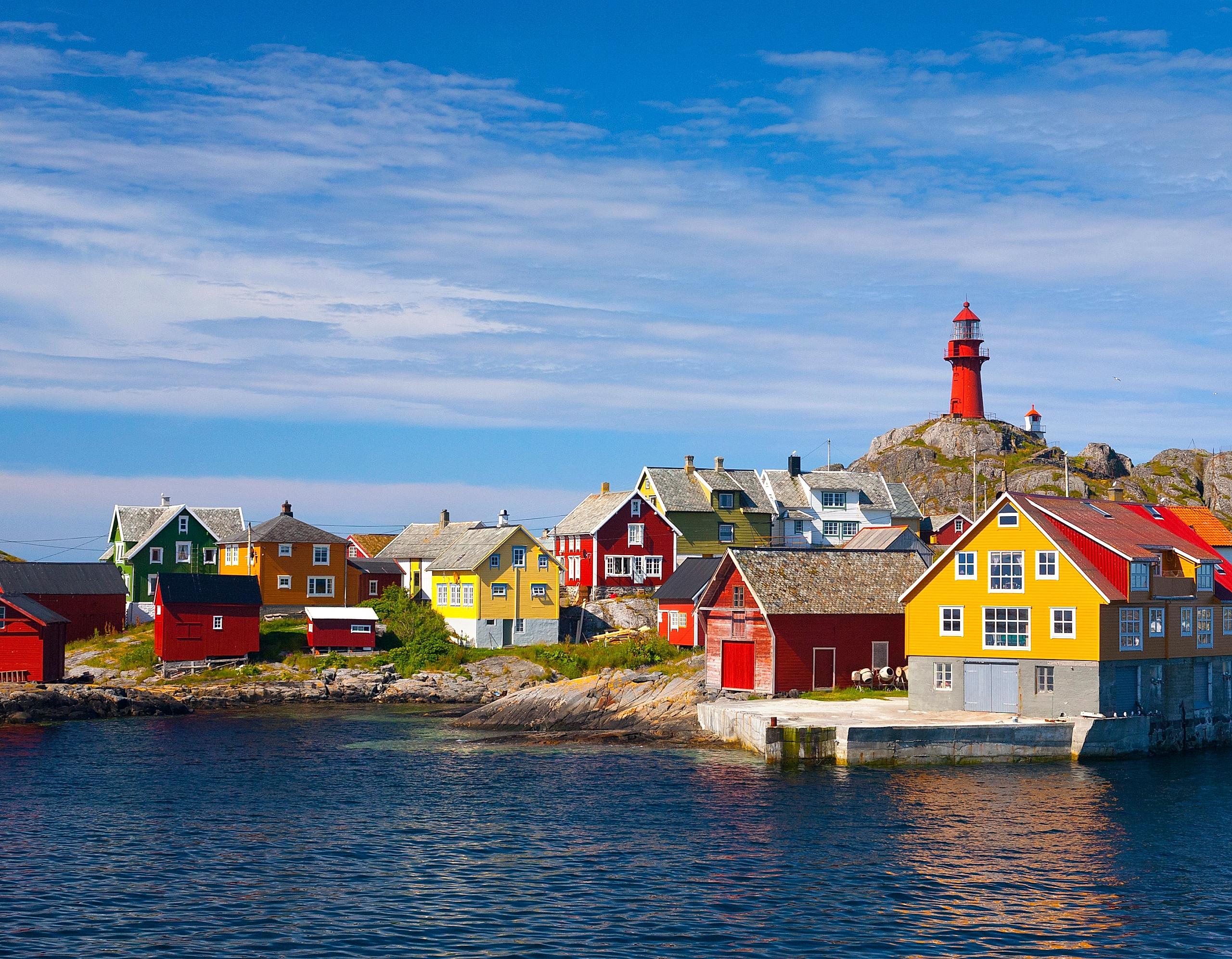 The Ona Lighthouse in Fjord Norway seen from the sea