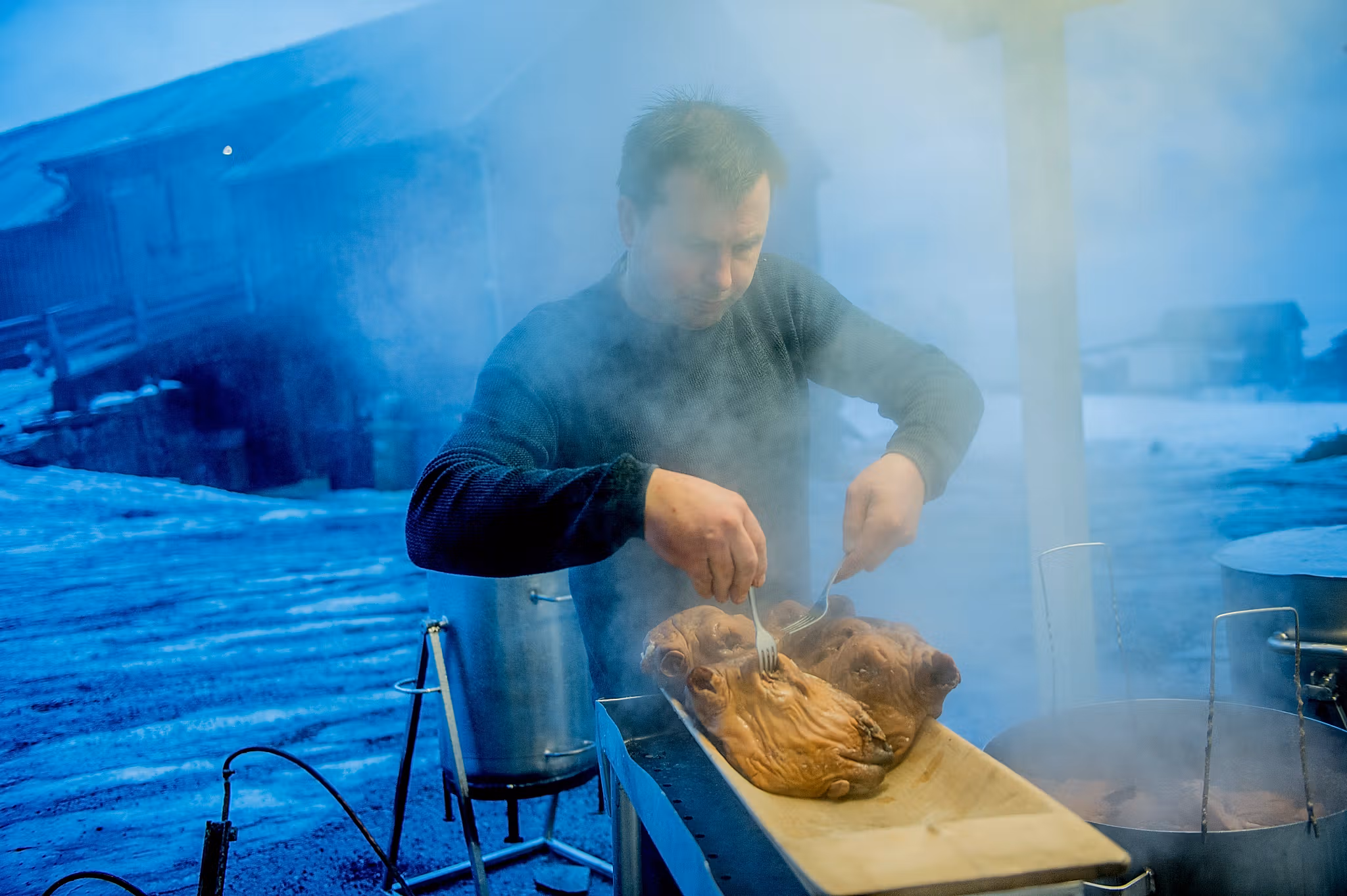 A person preparing a smalahove sheep’s head at Smalahovetunet in Voss, Fjord Norway