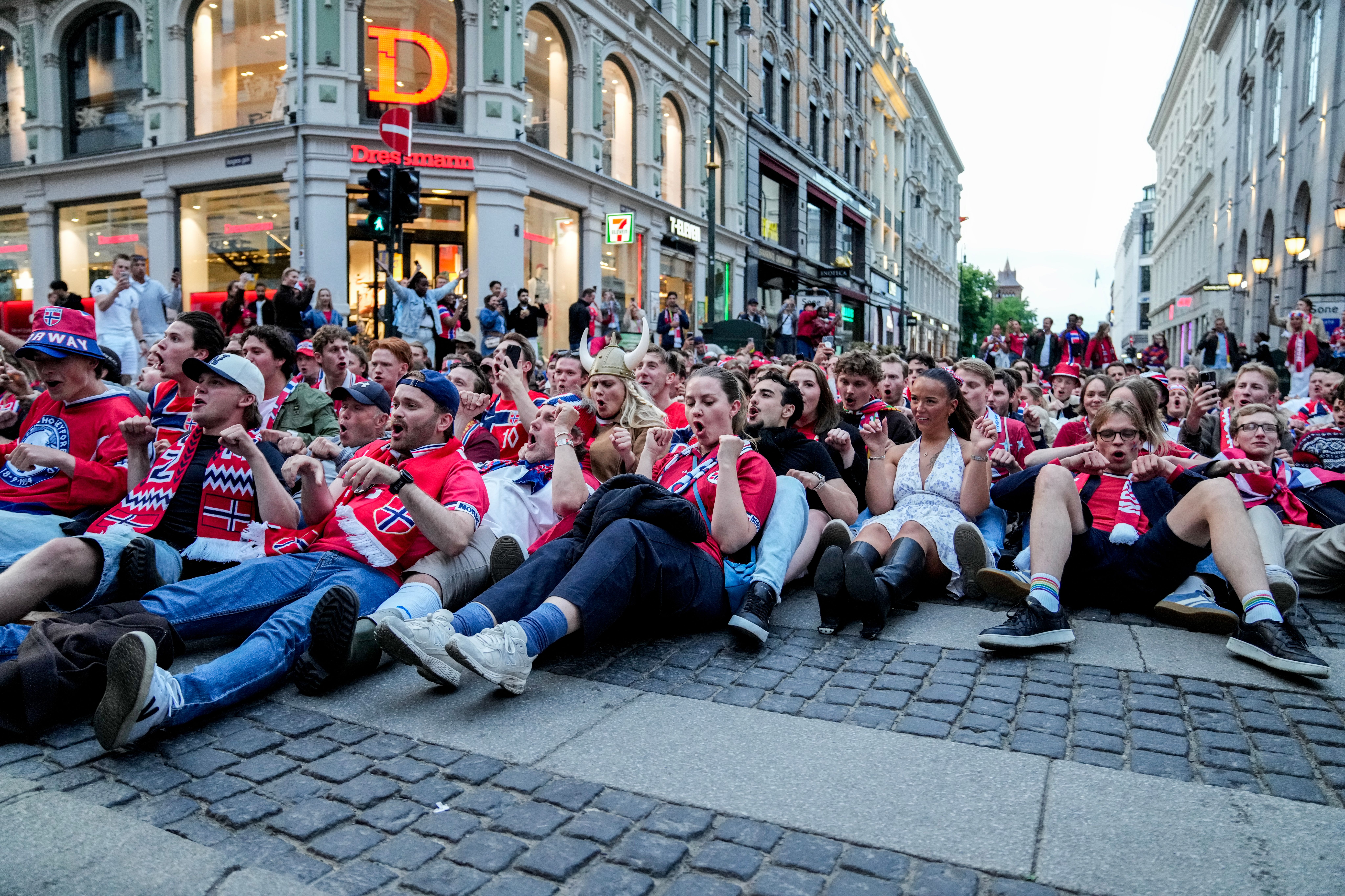 Many Norwegians sitting on the Karl Johan street and doing the Viking row