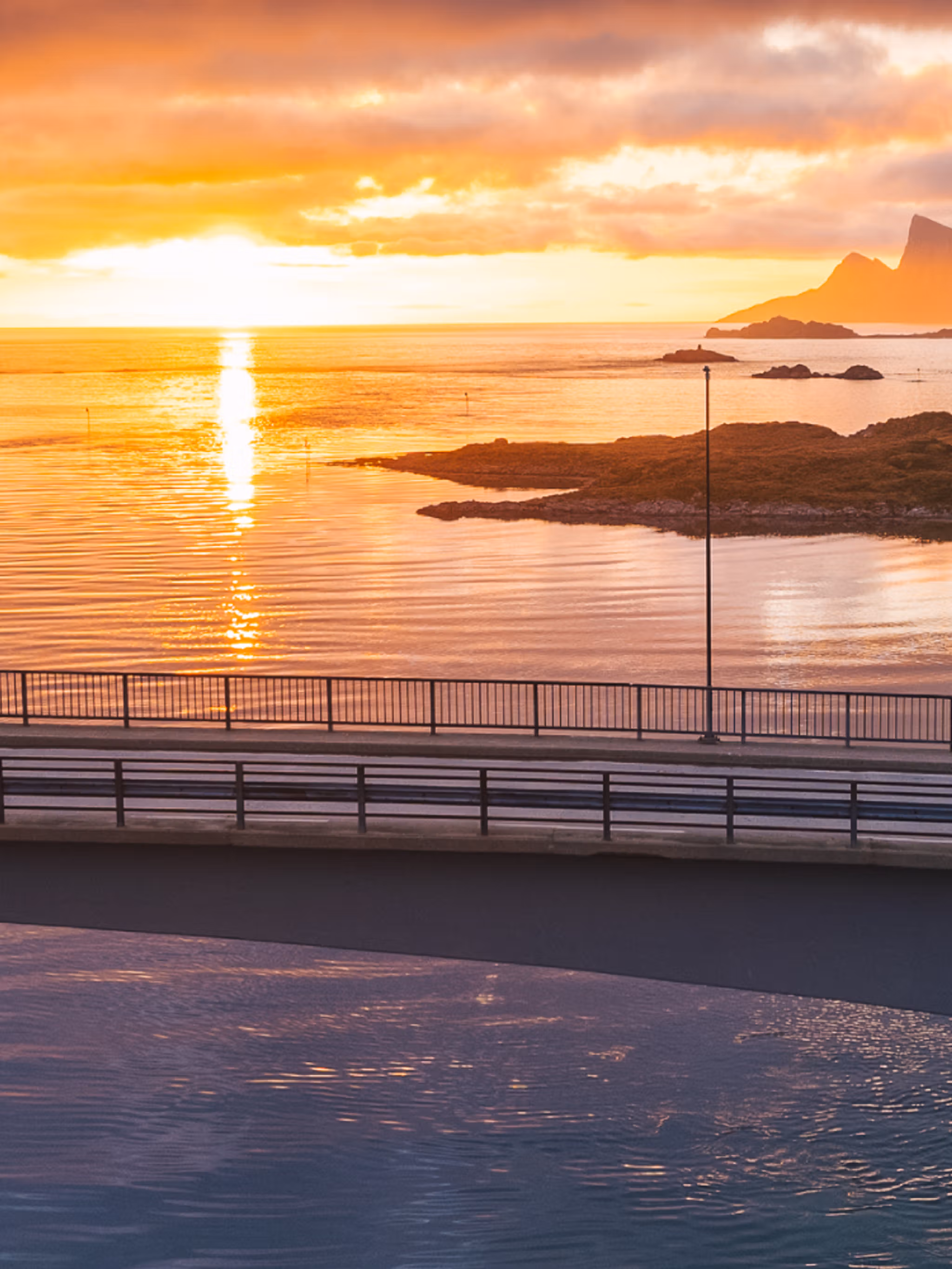 Two people exploring Lofoten under the midnight sun
