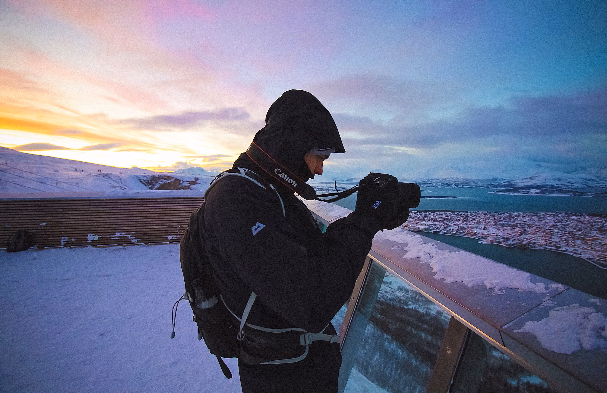 A tourist taking pictures from the top point of the gondola, Fjellheisen in Tromsø