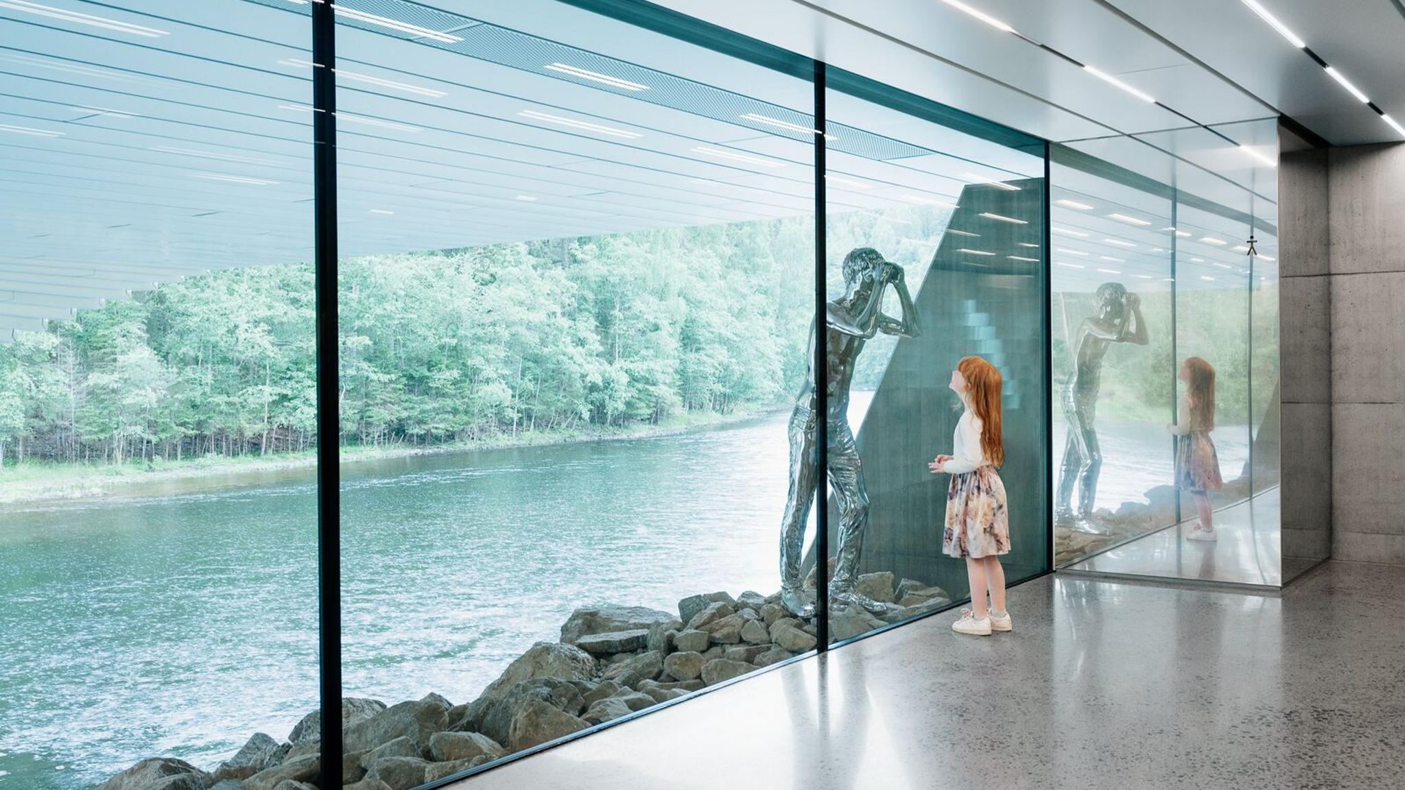 Girl looking at a silver sculpture at the Kistefos Museum in Norway