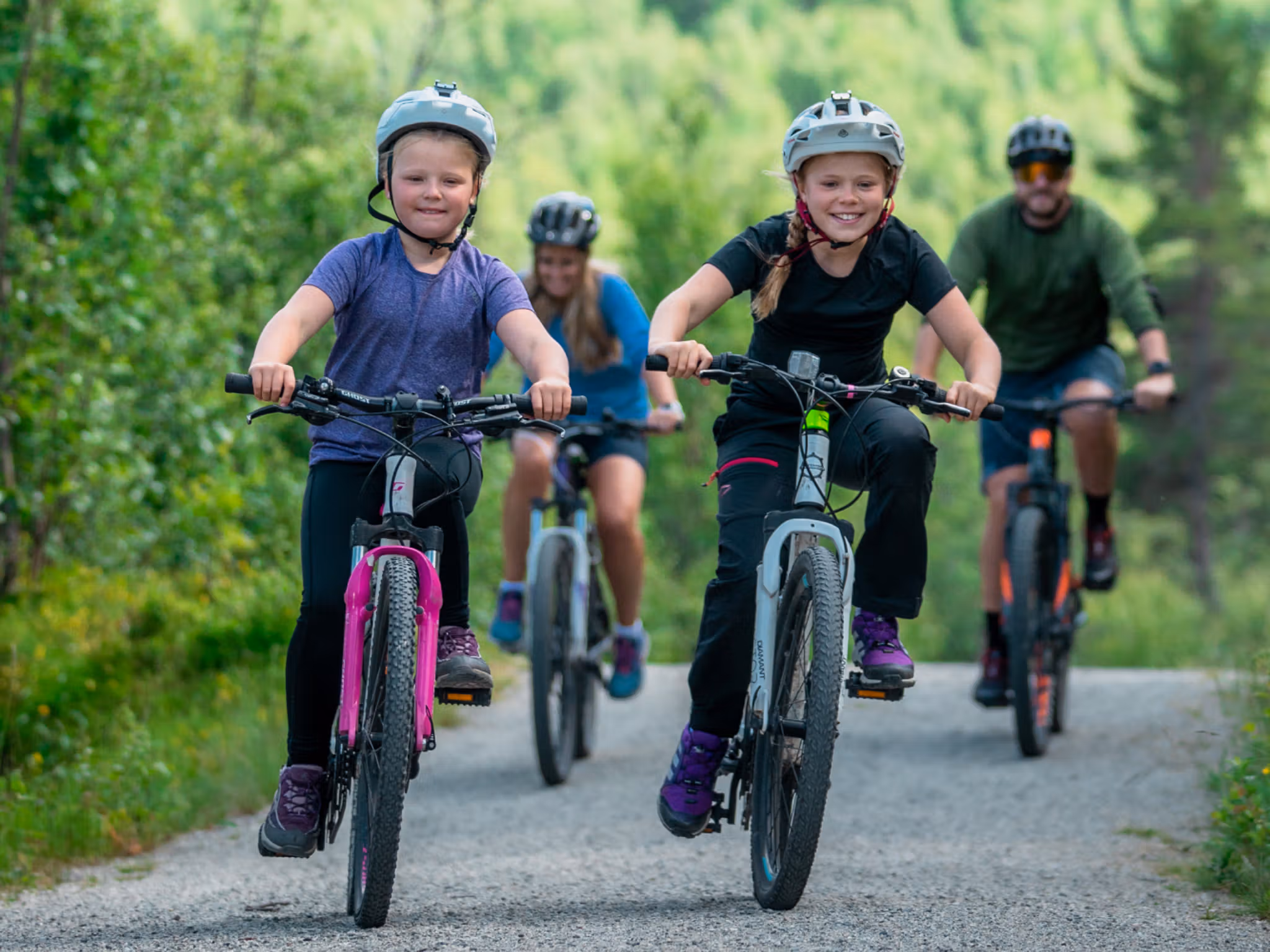 Family of four biking around Ustedalsfjorden in Geilo, Eastern Norway