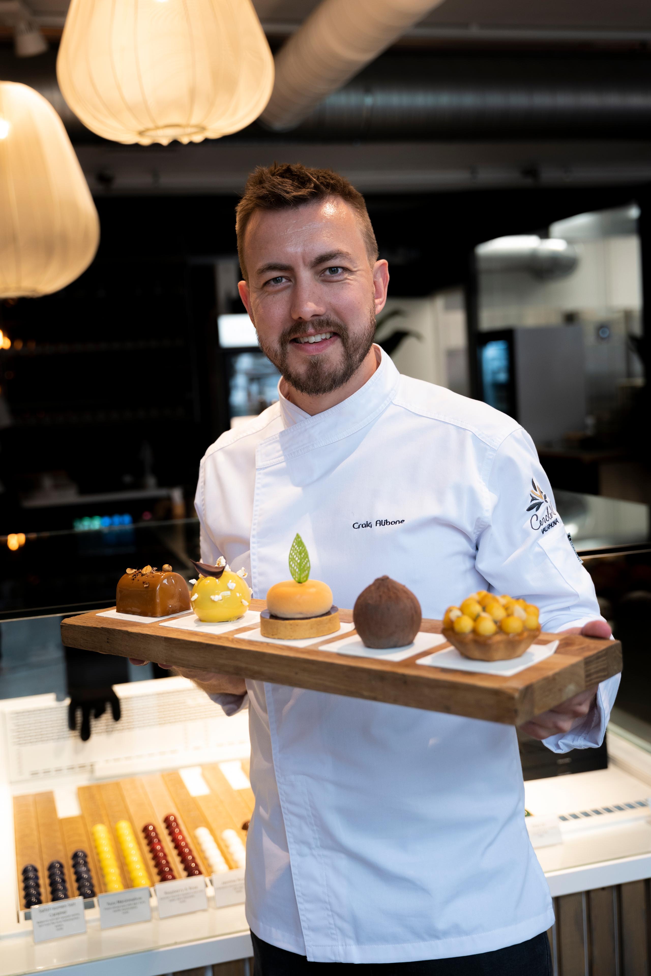 Craig Alibone holding some of his pastries in the patisserie Craig Alibone in Bodø, Northern Norway.