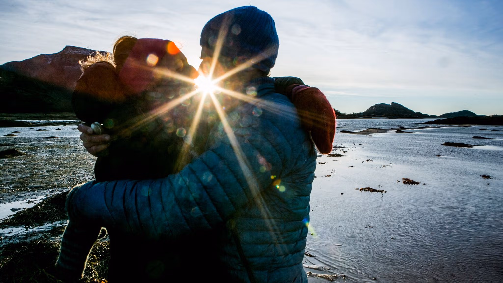 Couple kissing while picking cockles