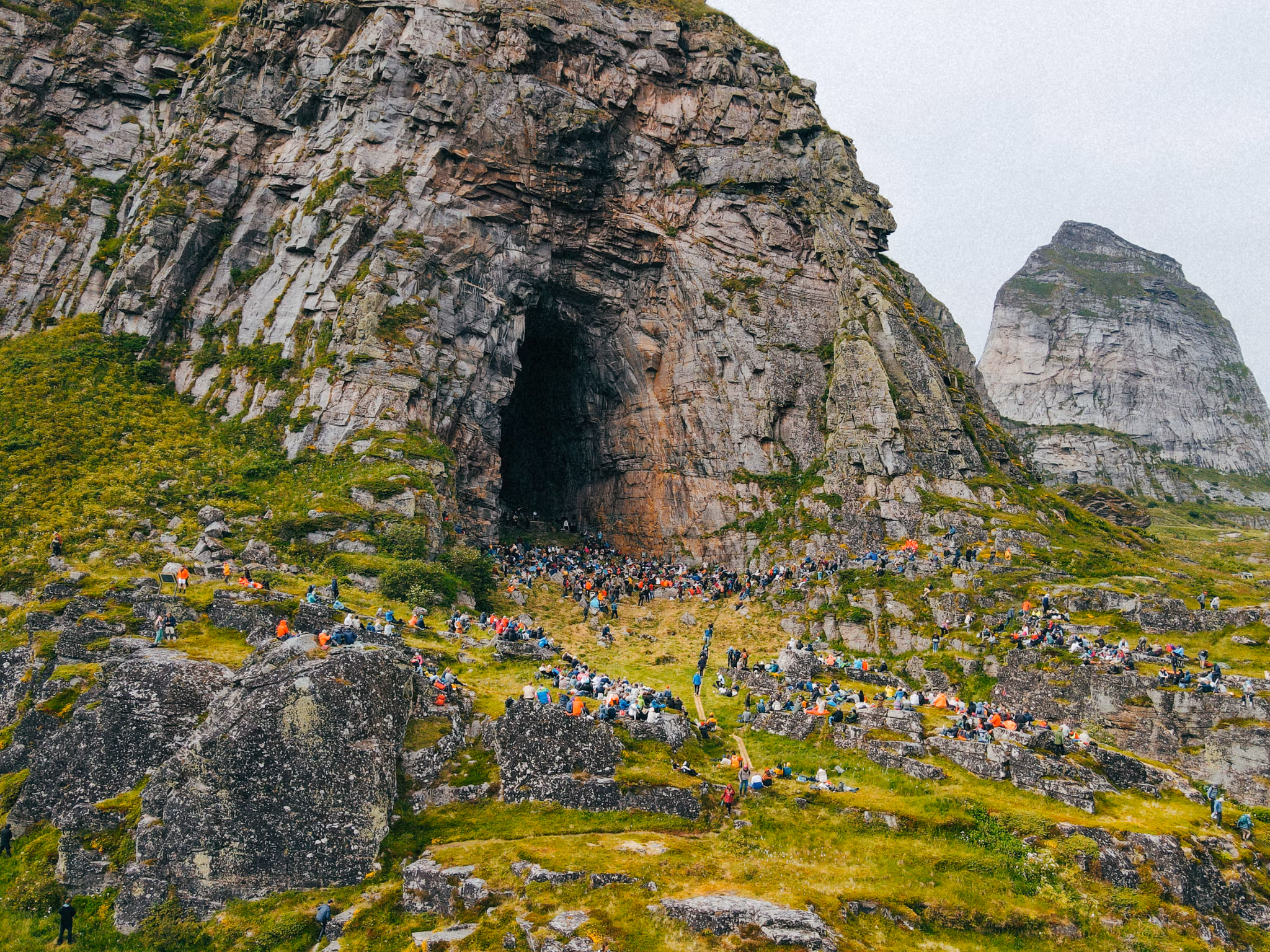 People at a concert in the Kirkhelleren cave in Træna, Helgeland, Northern Norway