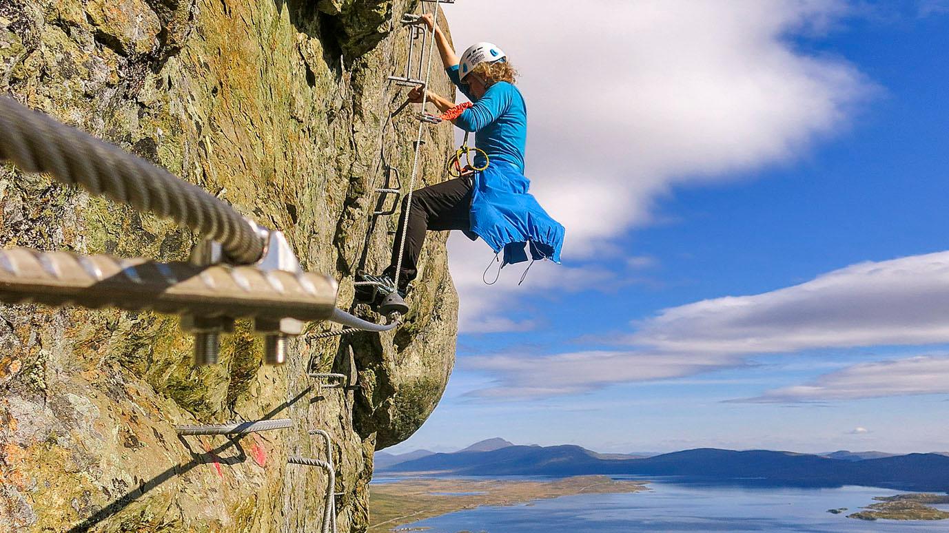 Woman climbing Via Ferrata Synshorn