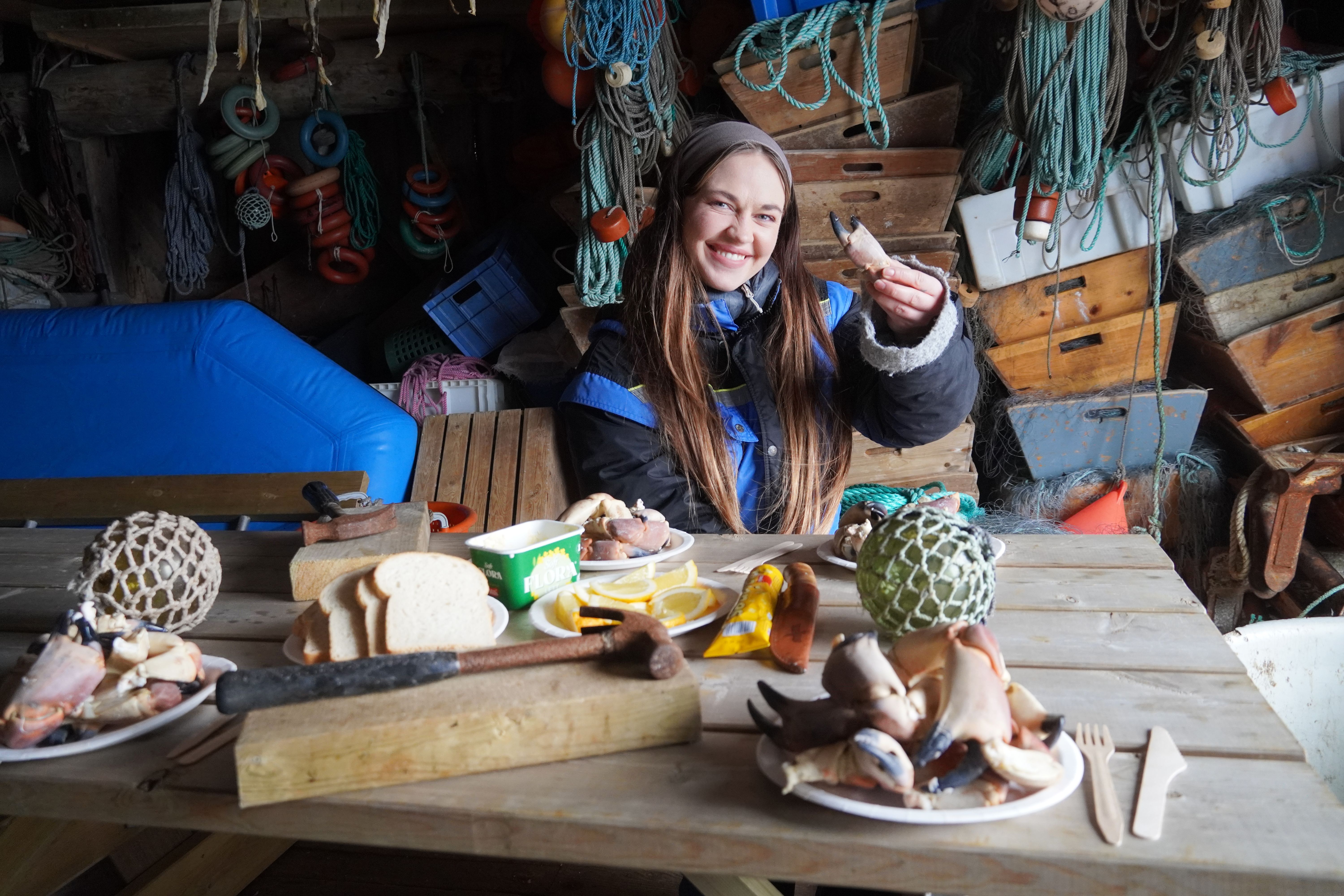 A woman eating crab meat.