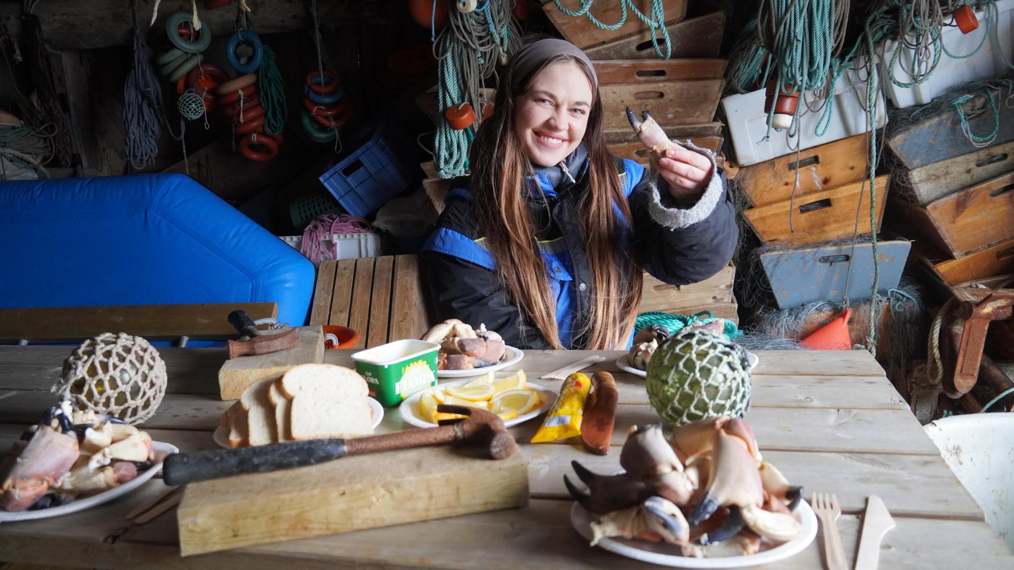 A woman eating crab meat.